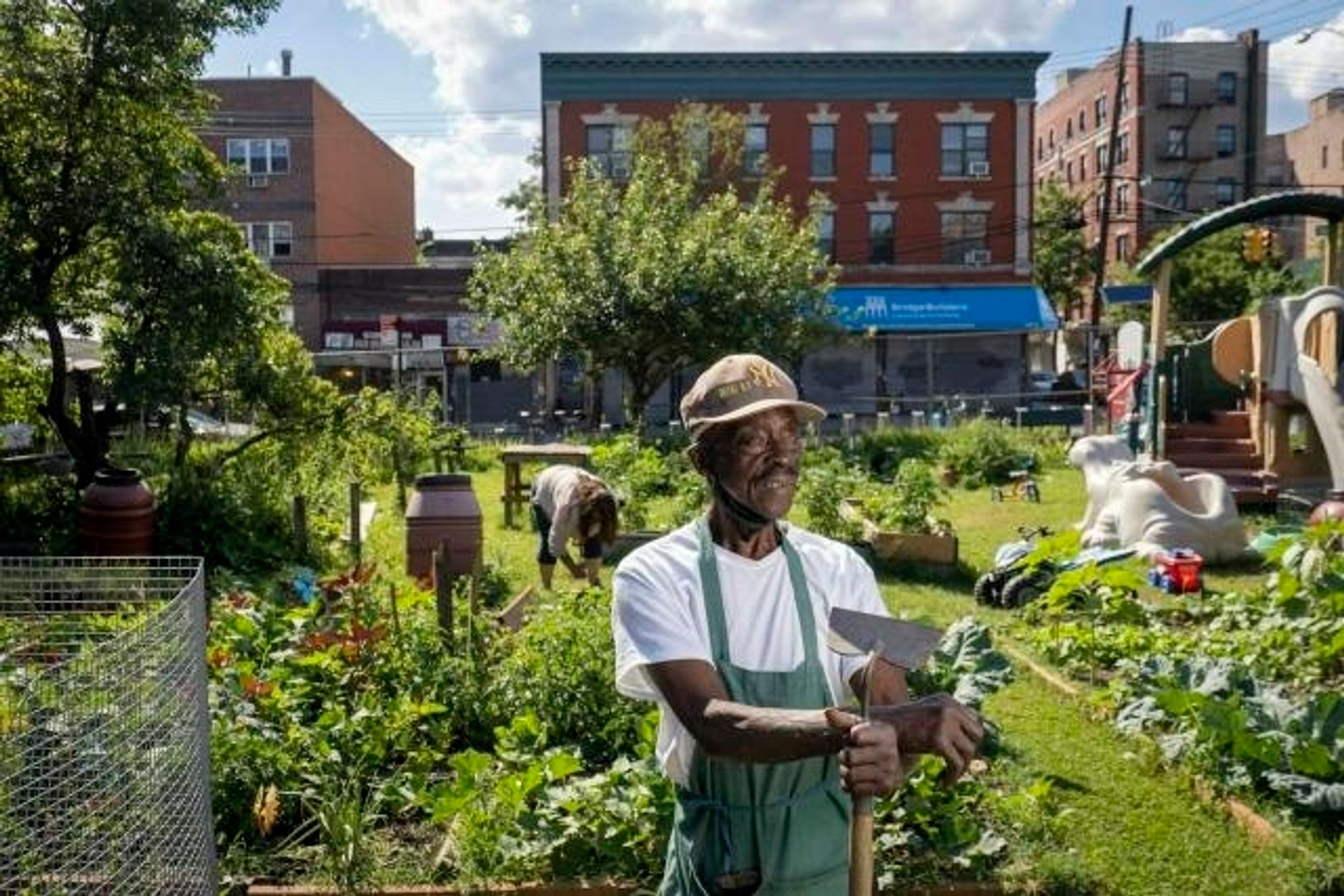 A man takes a well earned rest from his work in an urban garden.