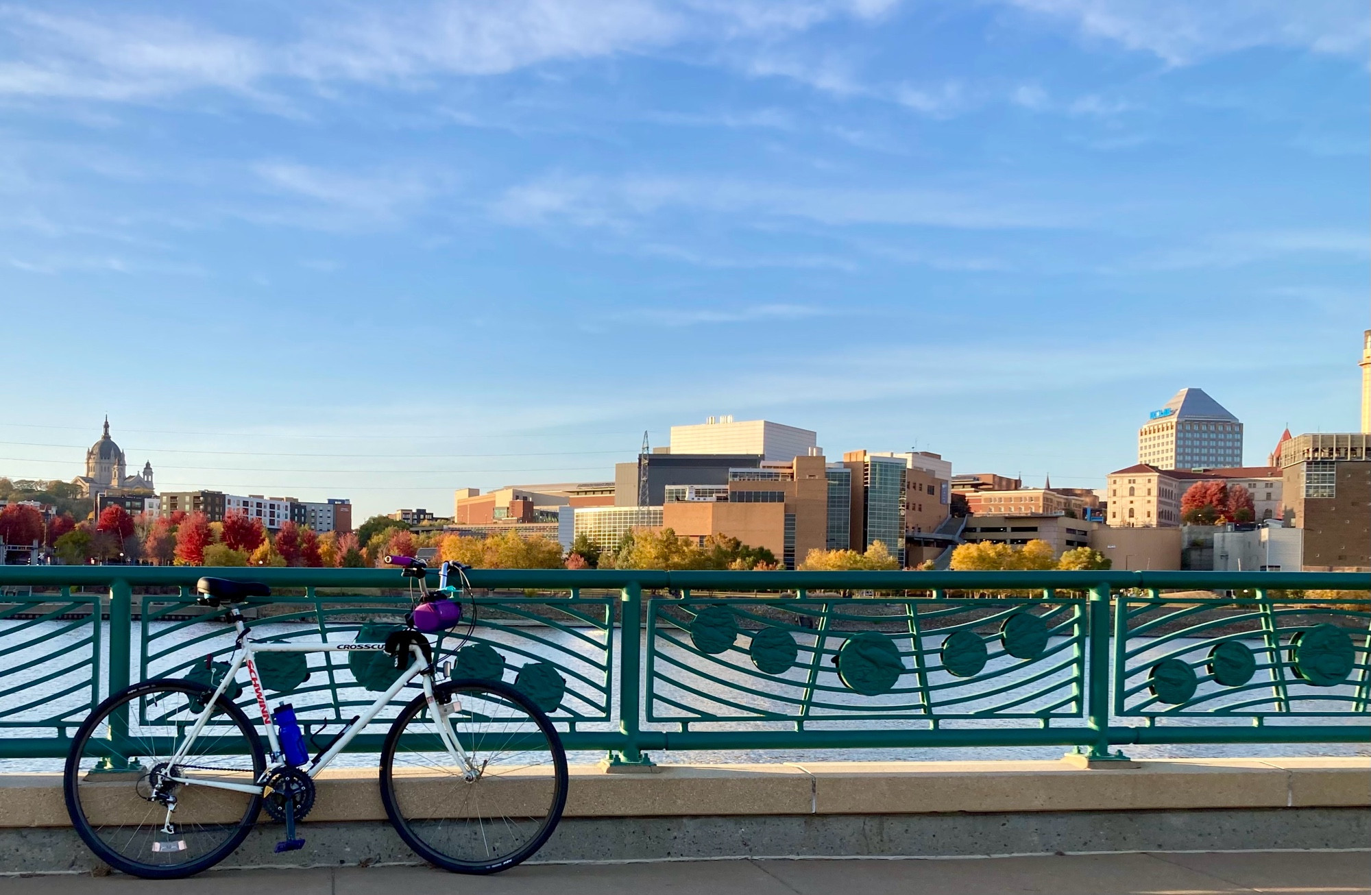 Same bike, same river, but this time there is a decorated metal railing and downtown Saint Paul in the background. 