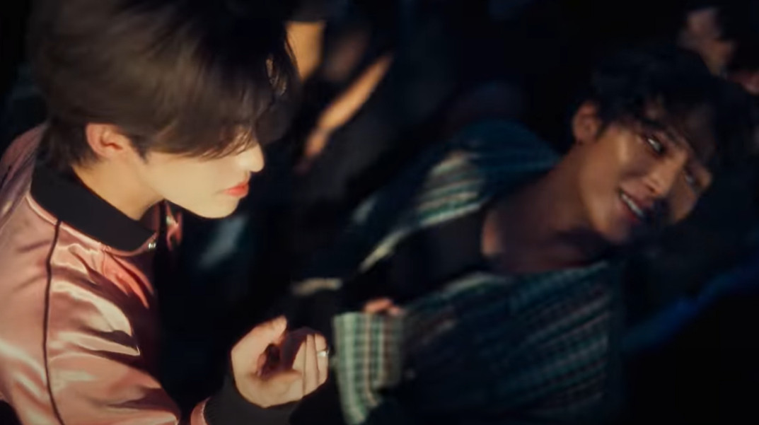 screenshot from the 'eyes on you' mv by kpop boy group seventeen, mingyu and seungcheol (scoups) dancing together in a club