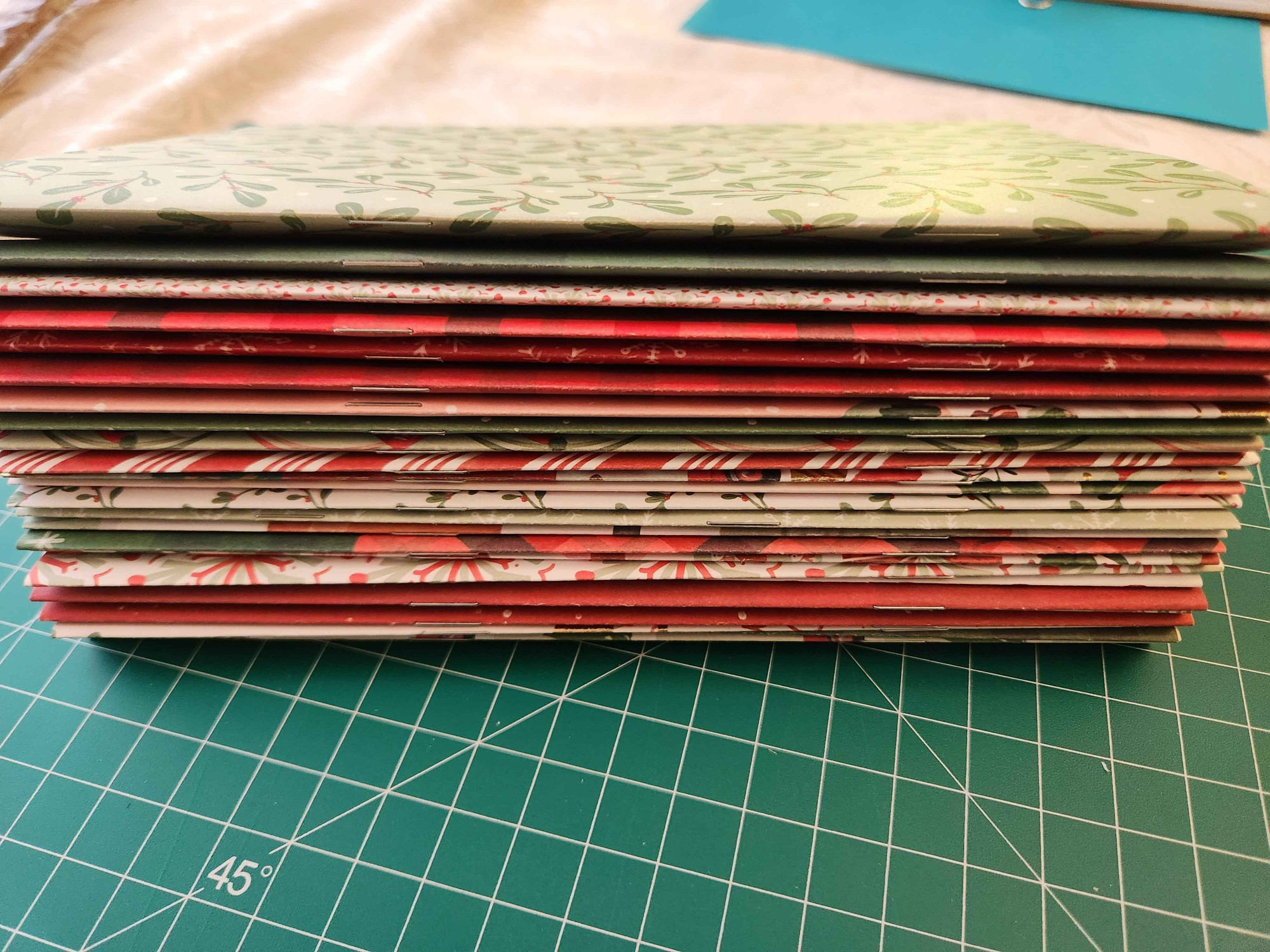 big chonky stack of booklets. i had to trim those cardstock covers to size too, and definitely they're not as even as i'd like them to be... folding was nice with this new paper though. the grain really does make a difference! 