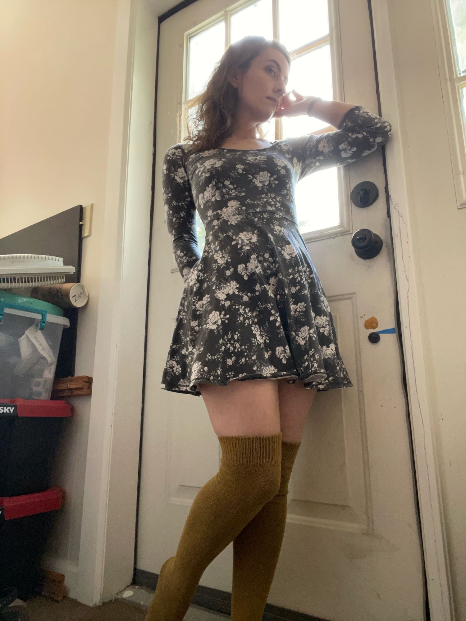 Posing against a door to show you my outfit. I am 34 by the way