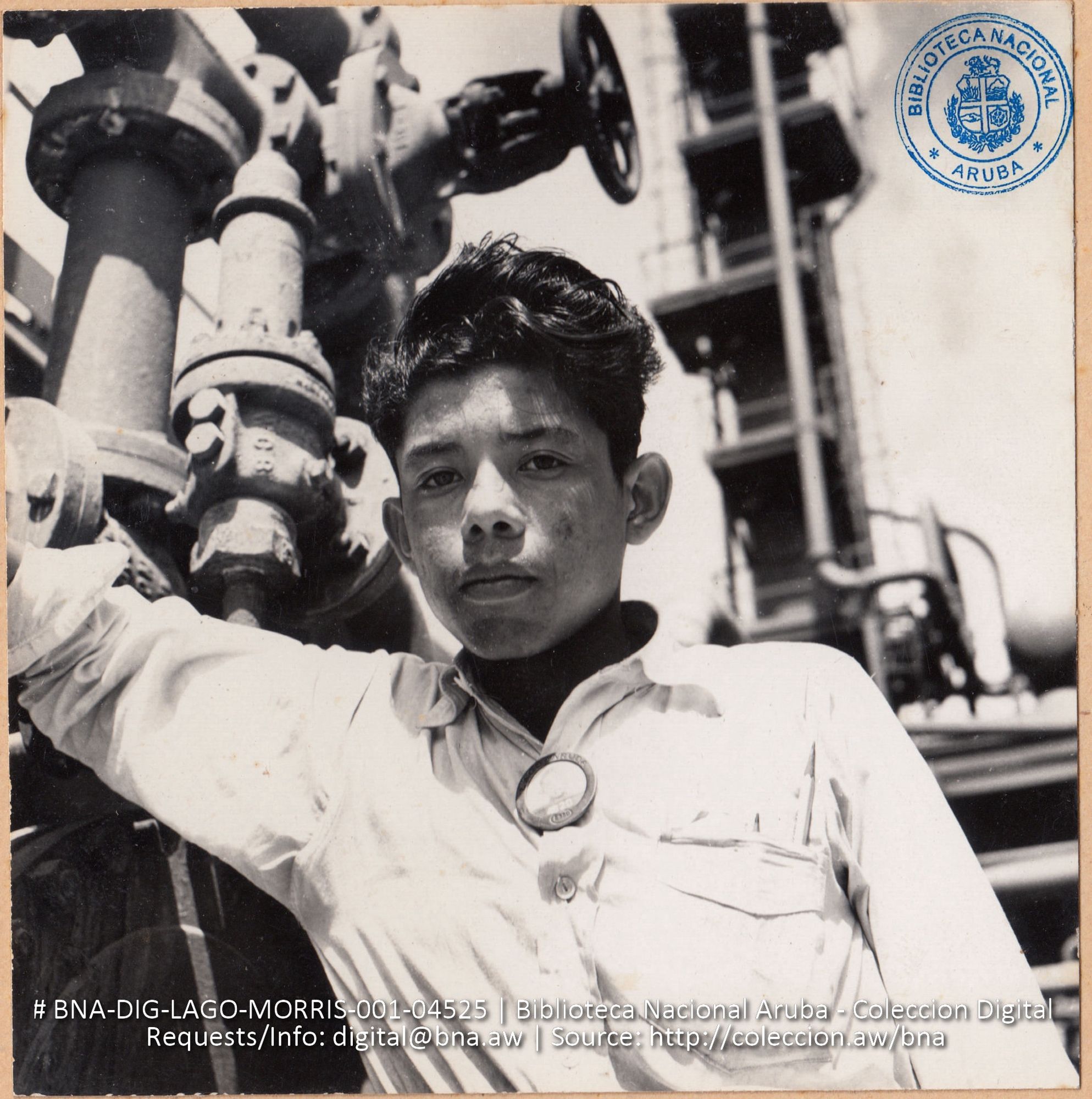 Leopold Tromp, age 18, native Aruban, Apprentice on Pressure Still operation (#4525, Lago, Aruba, April-May 1944). From Coleccion Aruba: https://archive.org/details/BNA-DIG-LAGO-MORRIS-001-04525