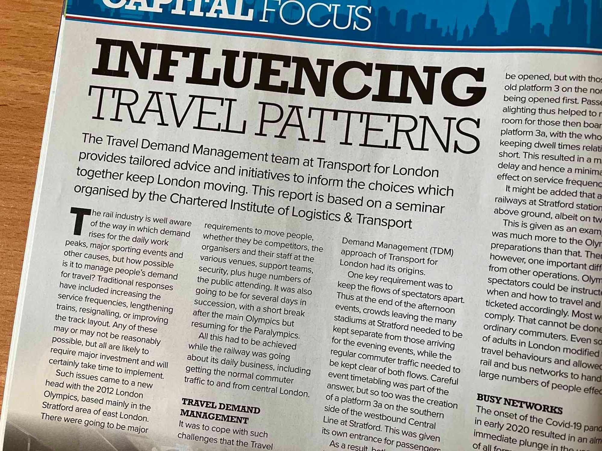 Photo of part of a magazine article. 
The headline is "Influencing travel patterns". The standfirst is "The Travel Demand Management team at Transport for London provides tailored advice and initiatives to inform the choices which together keep London moving. This report is based on a seminar organised by the Chartered Institute of Logistics & Transport."
The text of the article goes on to talk about how the London 2012 Olympics and Paralympics were the origin of TfL's travel demand management approach.