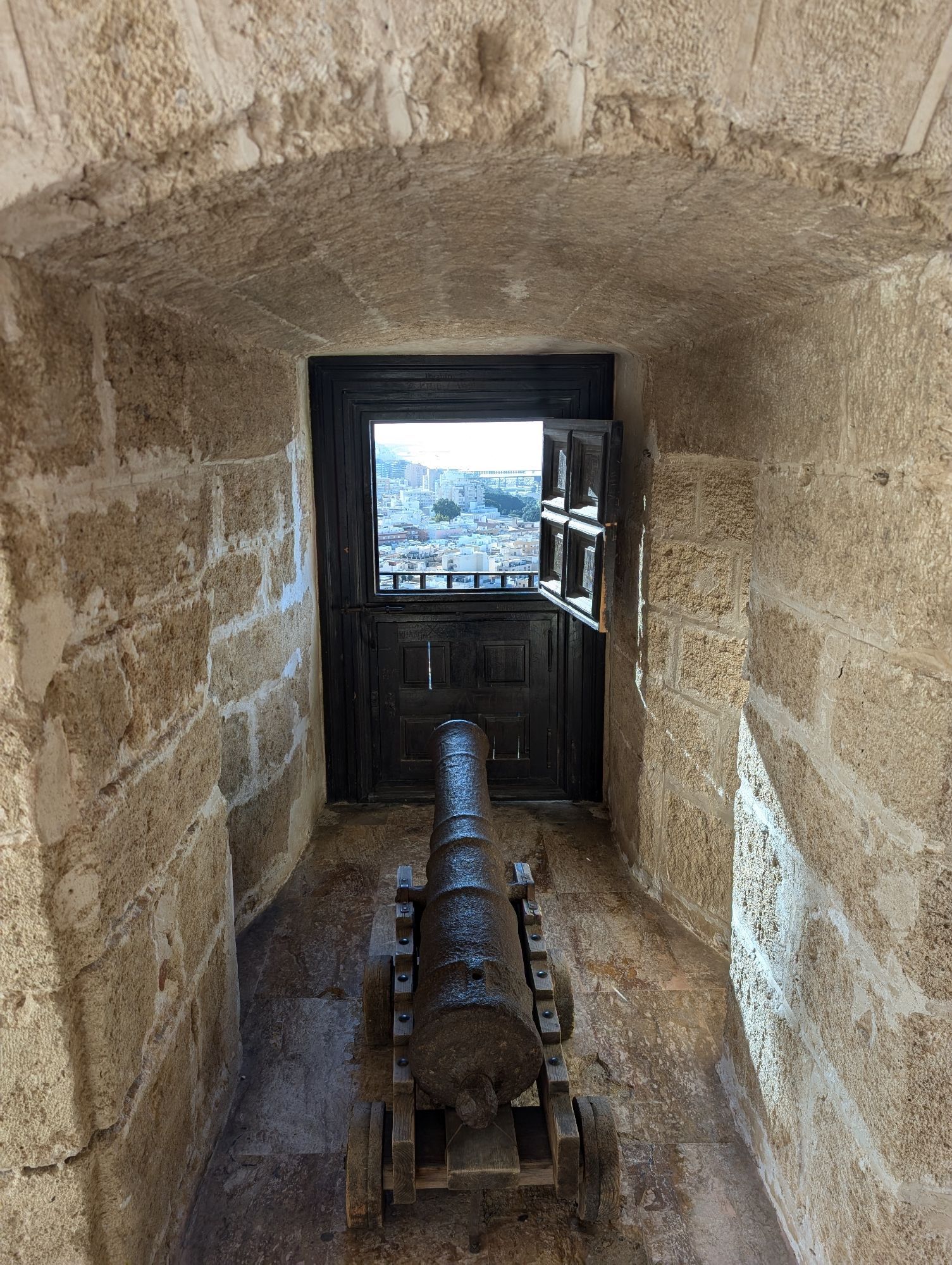 A cannon looks out of the Christian fortress of the Alcazaba over the town of Almeria