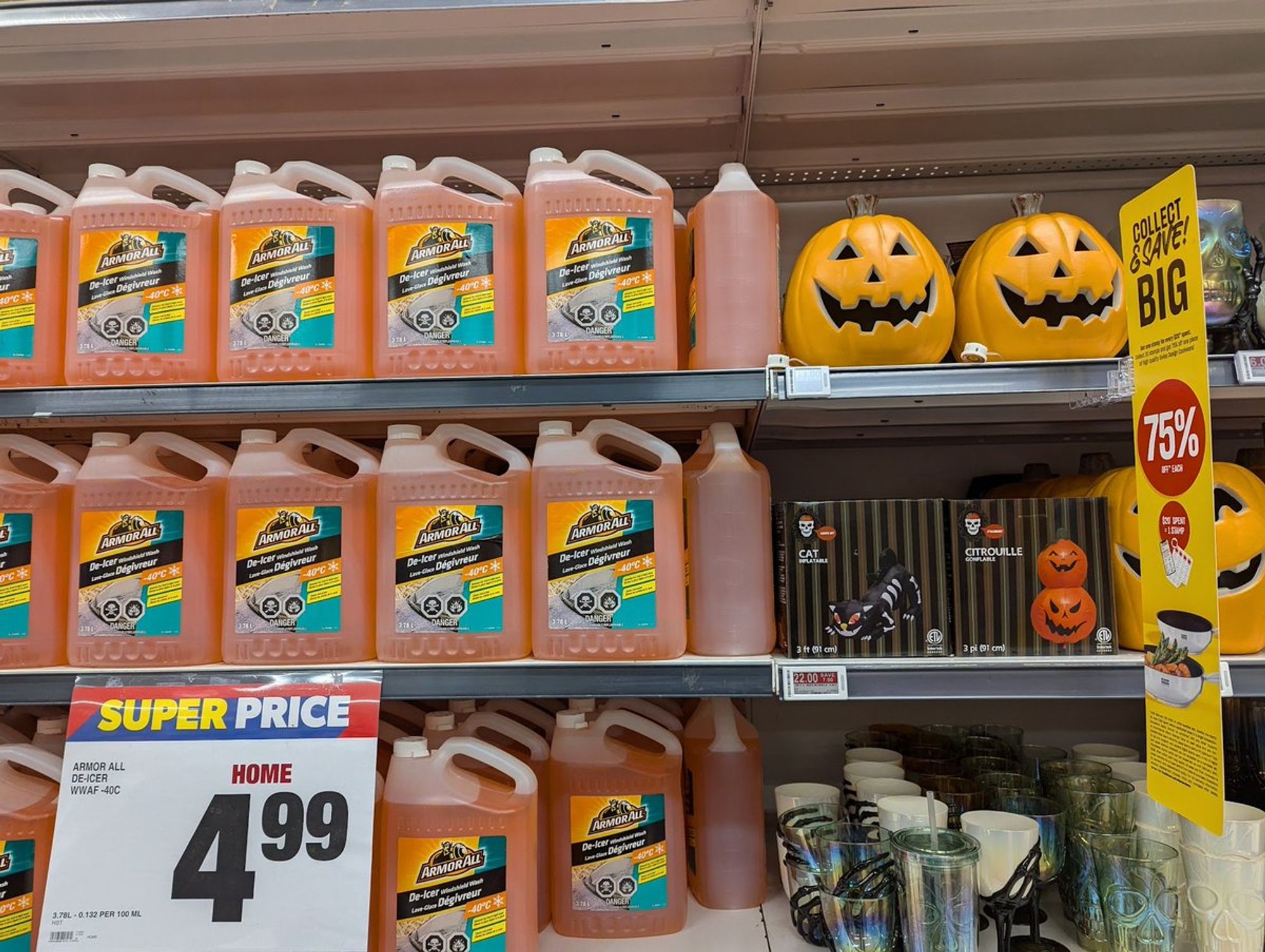 A display shelf with ceramic pumpkins and pumpkin-coloured windshield washer fluid