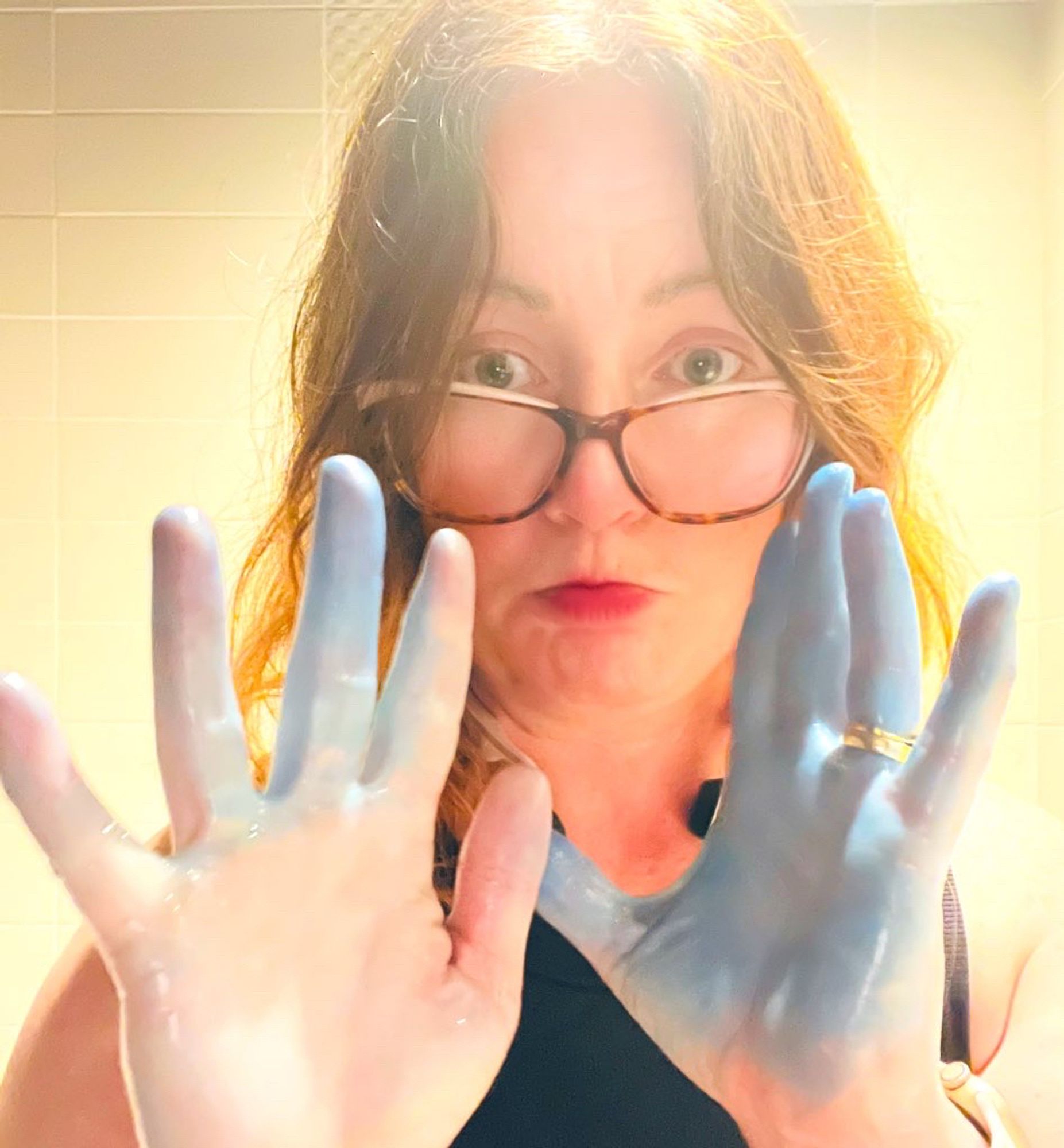 A selfie of me, a mid-30s white woman with pale skin and blue dyed hands