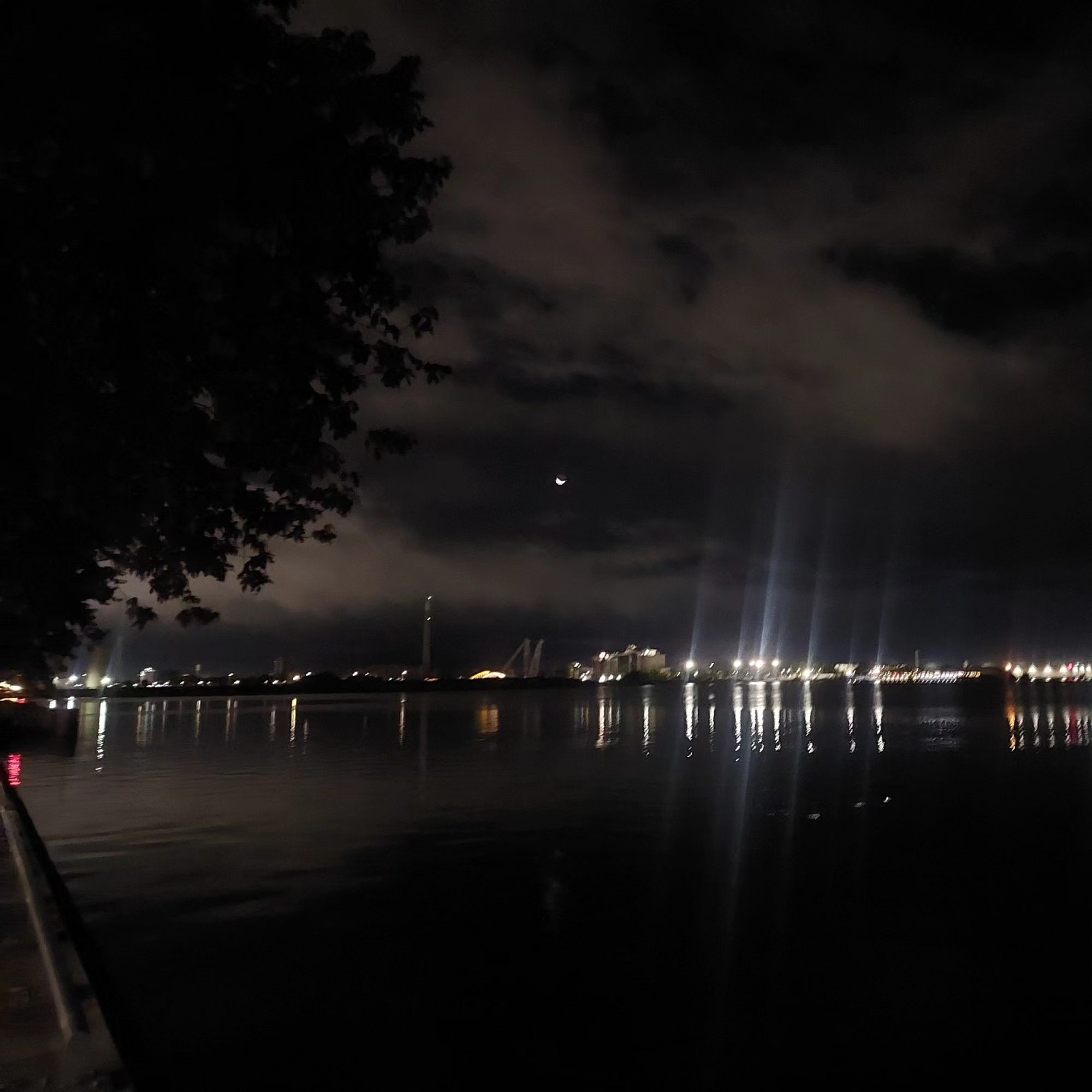 blurry photo of the crescent moon over the lake