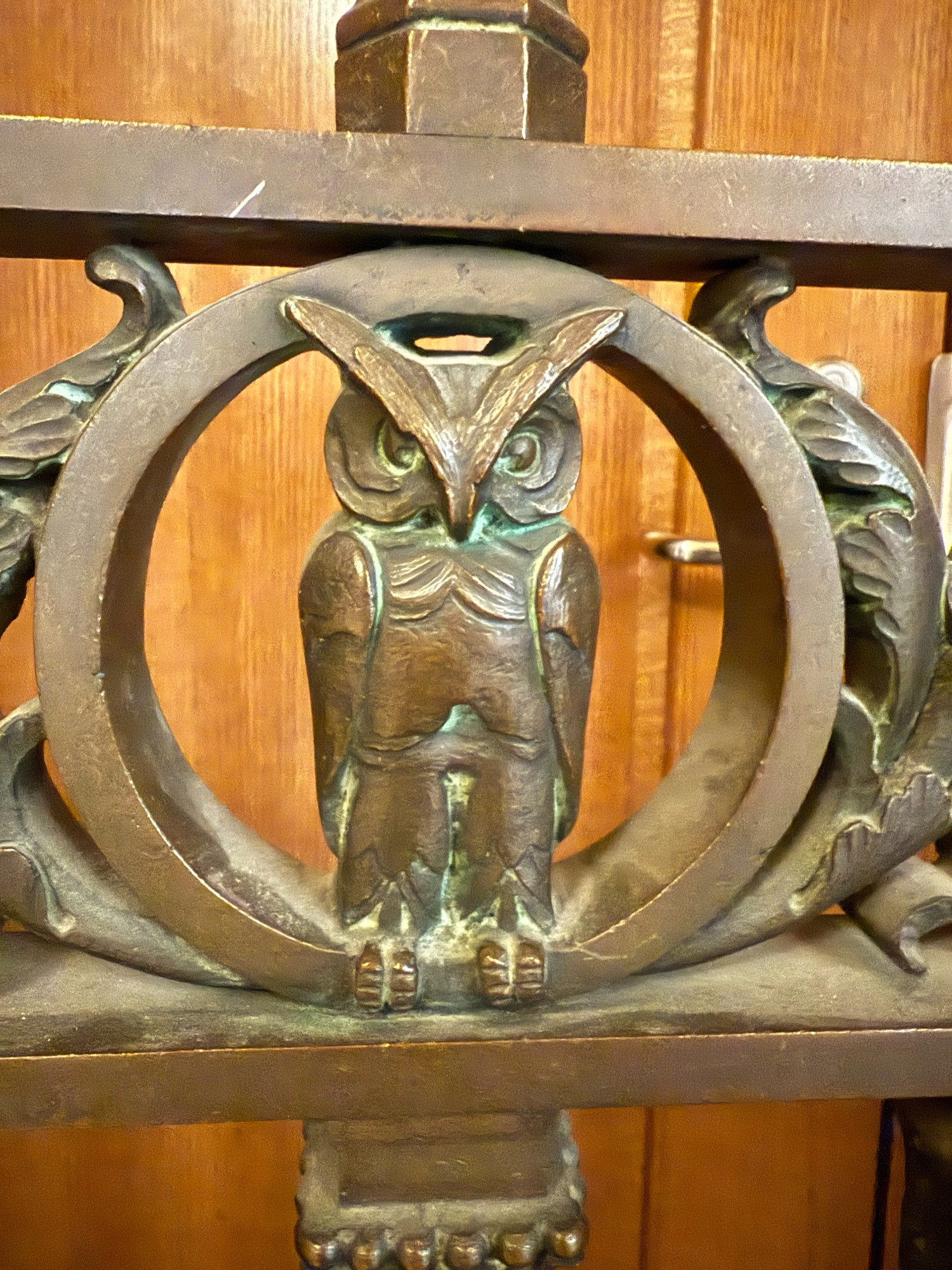 Bronze owl in a door gate.