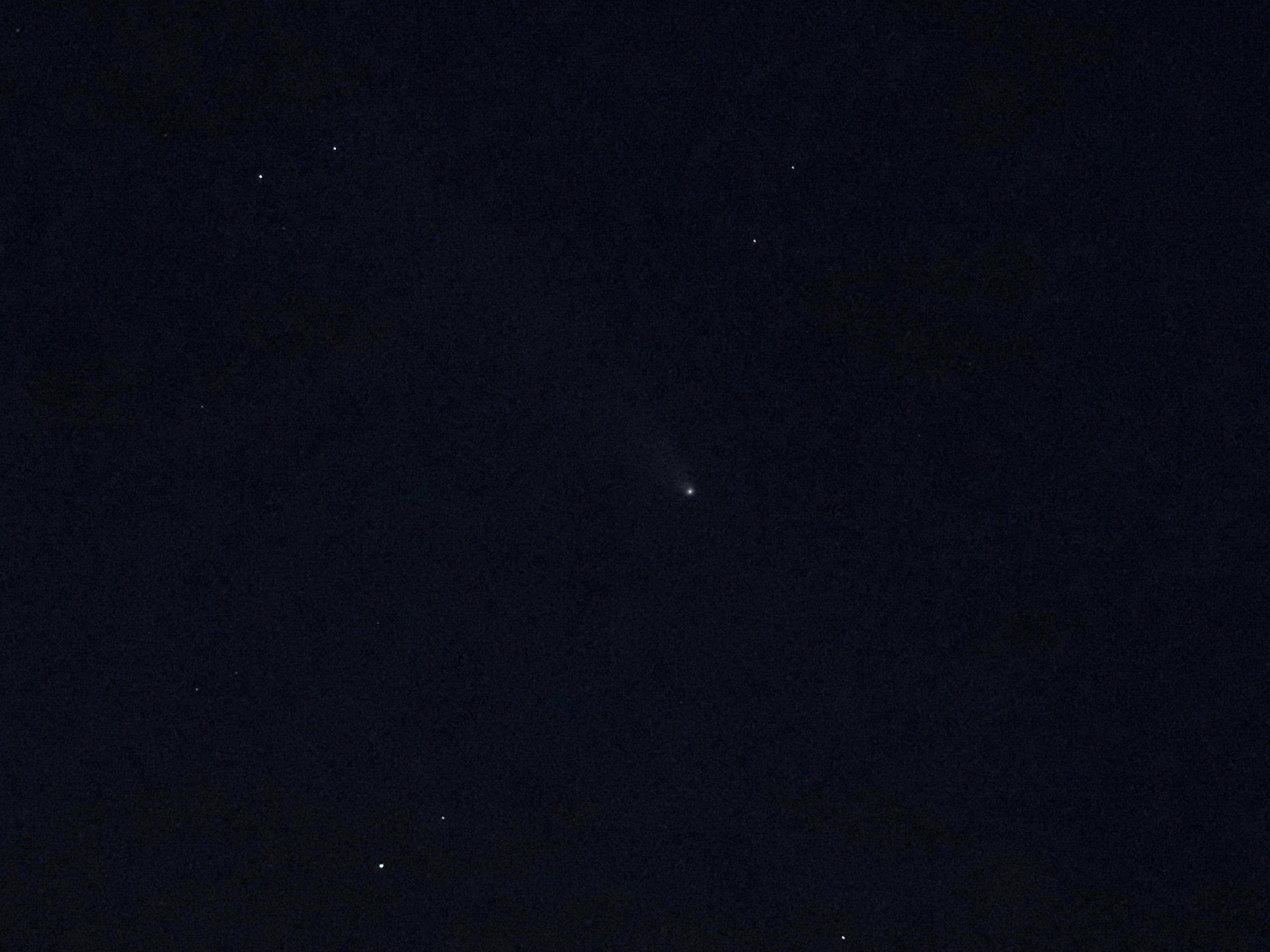 Comet Atlas. A very faint fuzzy blob with a hint of a tail to the top left.