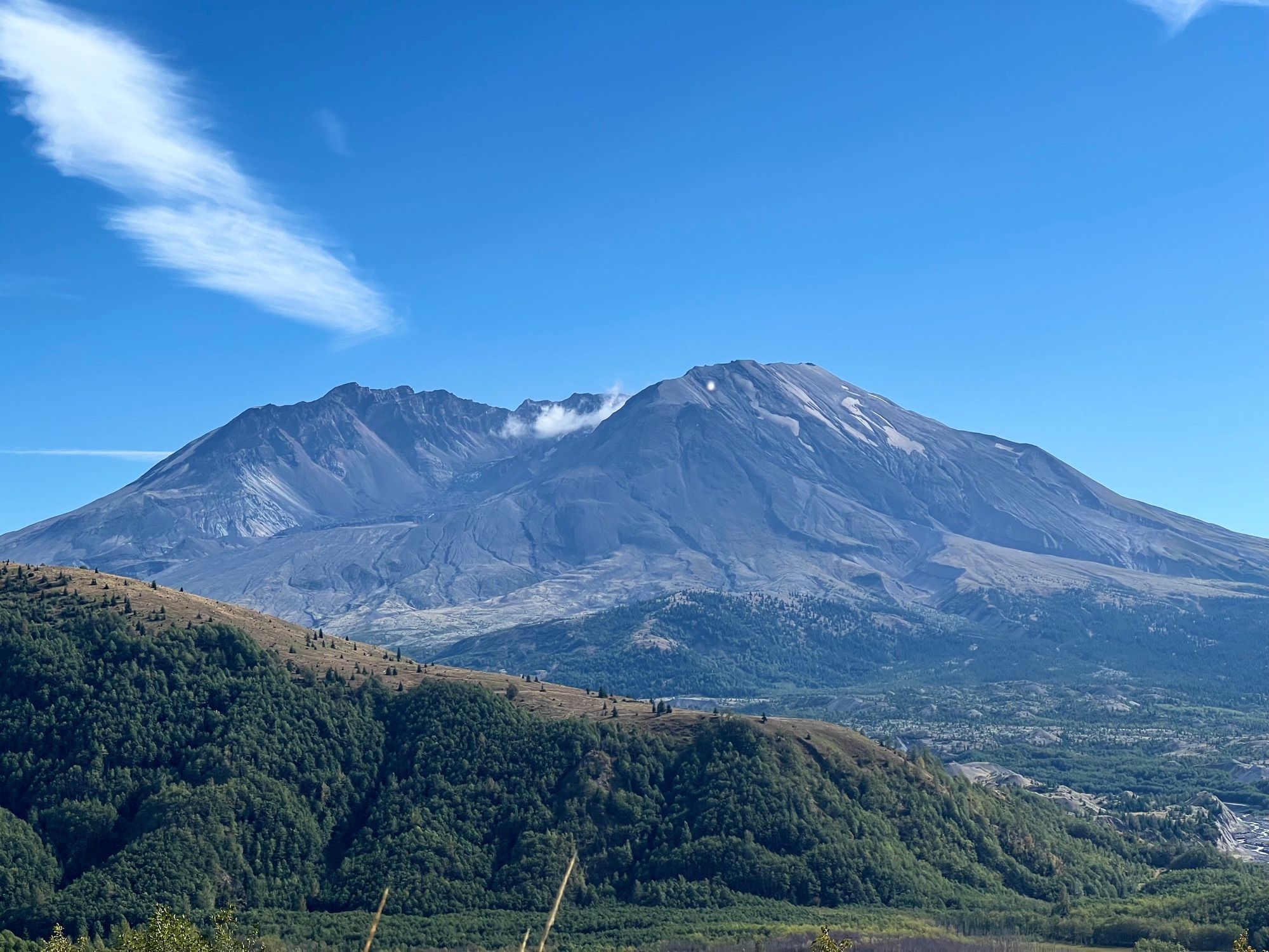 Mt. St. Helens, with a poof of steam above the growing lava dome.