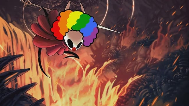 A digital illustration shows Hornet from the game Hollow Knight, wearing a rainbow clown wig and a red clown nose. She is posed mid-leap in a boss arena, with flames raging in the background.
