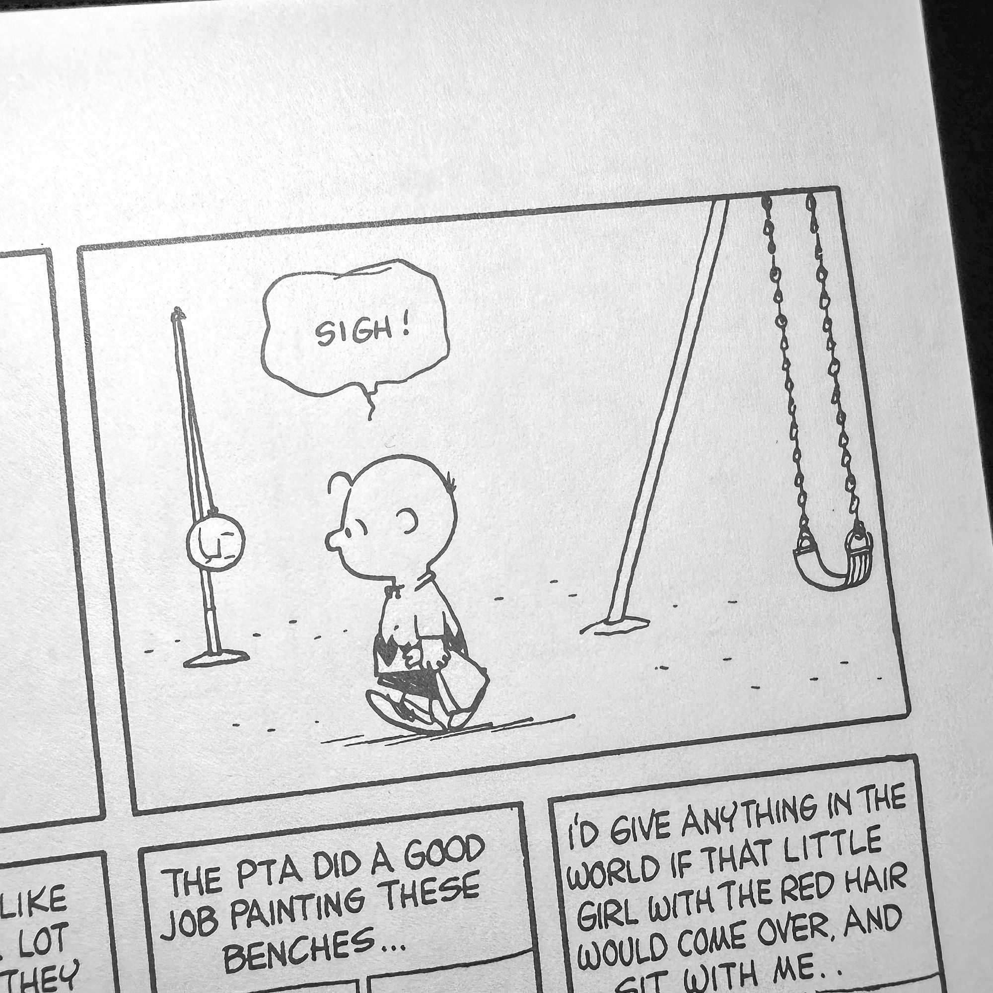 A black-and-white comic strip featuring a small child expressing a sigh, standing alone near a swing set and a tetherball court 