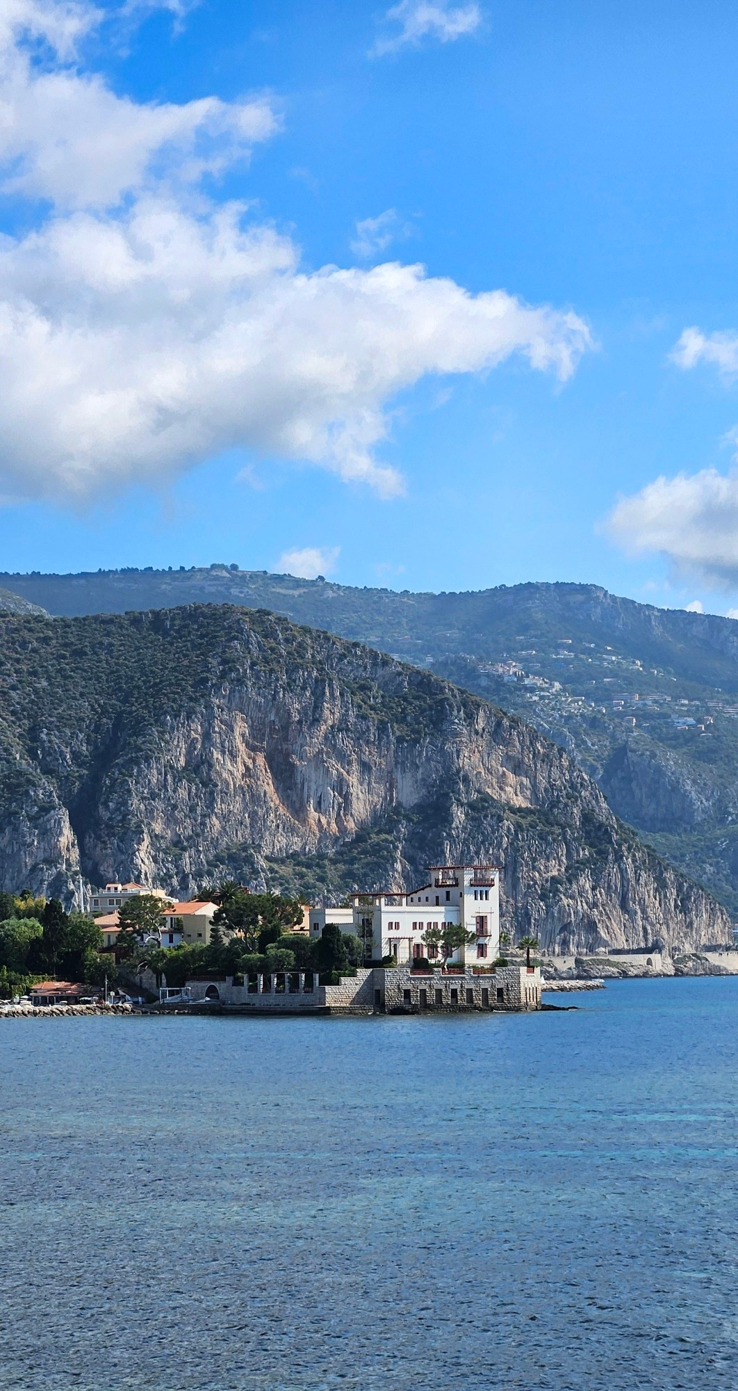 A villa by the sea with a beautiful mountain backdrop. The villa was built in the very early 1900s in an ancient greek revival style. It's been owned by the french state for almost 100 years and is now a museum.