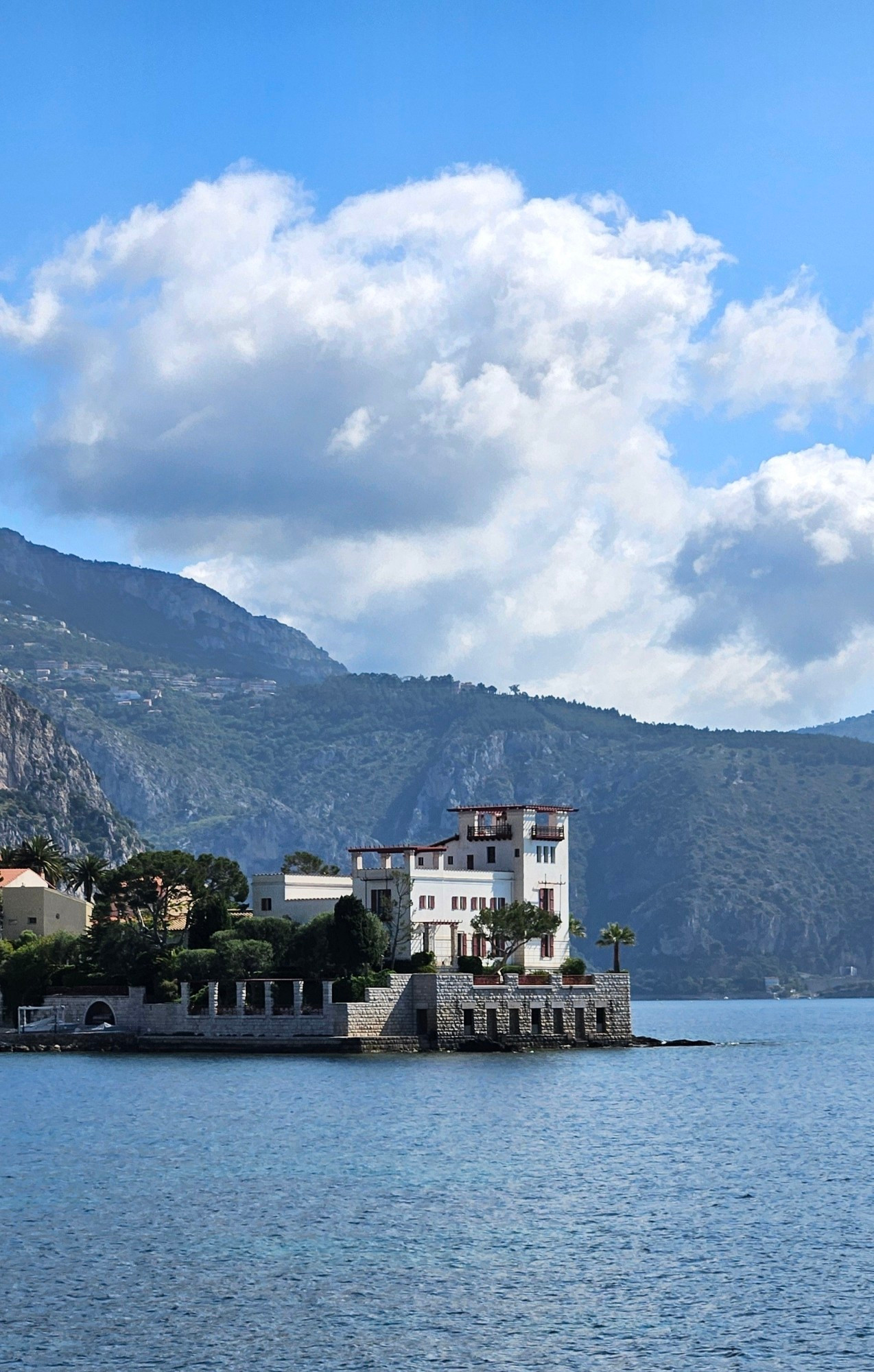 A villa by the sea with a beautiful mountain backdrop. The villa was built in the very early 1900s in an ancient greek revival style. It's been owned by the french state for almost 100 years and is now a museum.