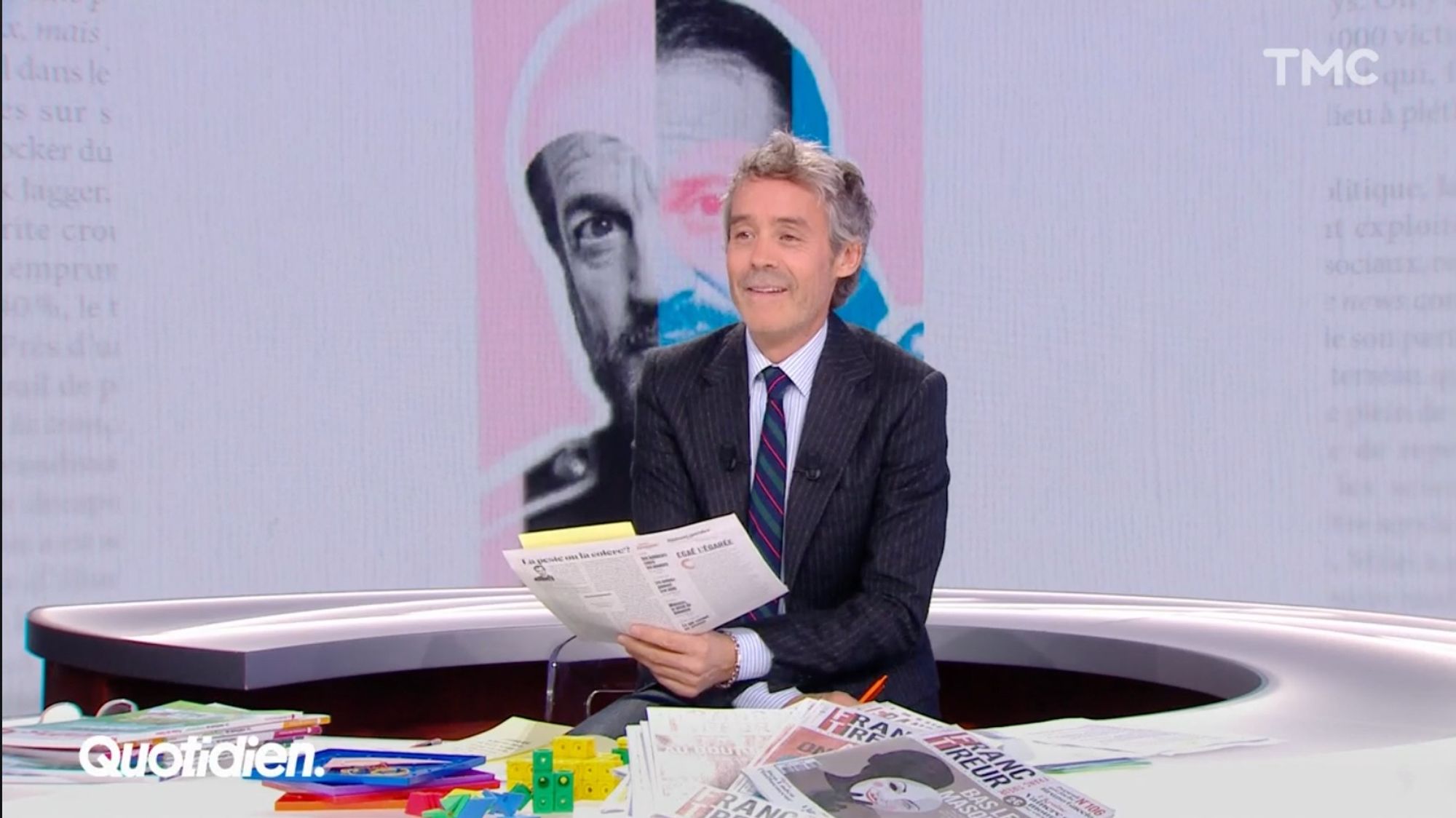 Capture d'écran de Yann Barthès dans Quotidien. Derrière lui, le portrait de Lalanne dans Franc-Tireur.