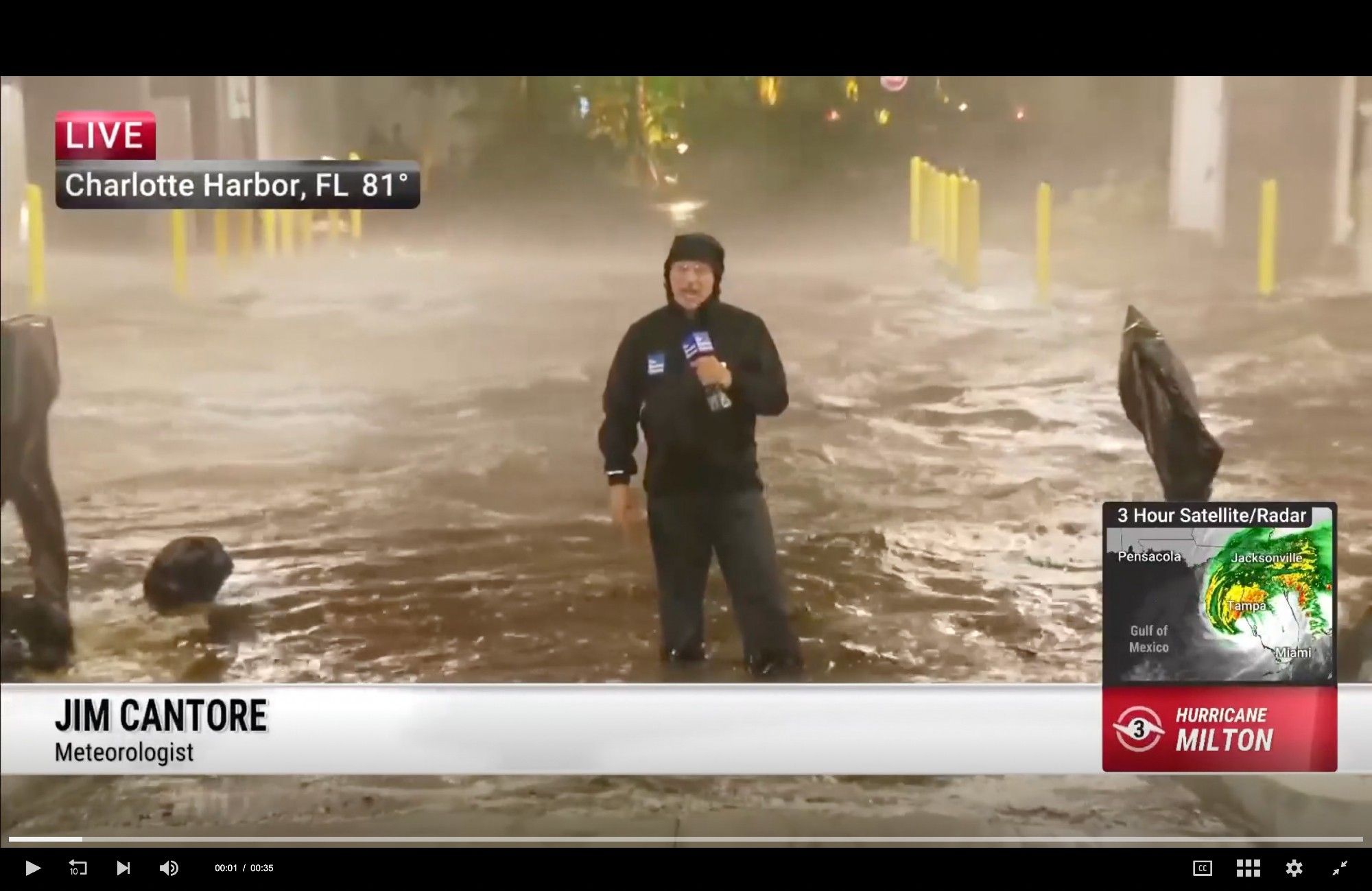 Screenshot of a TV meteorologist standing in a flooded parking lot during Hurricane Milton to show how windy and wet it is outside.