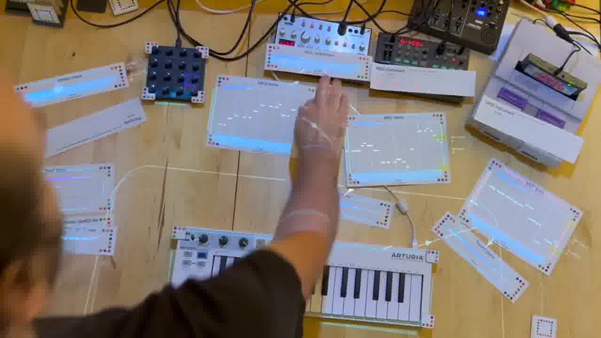 An example of Dynamicland, in which a physical computer keyboard is used in conjunction with computer-generated images projected on the table on which the keyboard sits. Cardboard cards marked with color dots (to enable computer recognition) contain programming instructions.