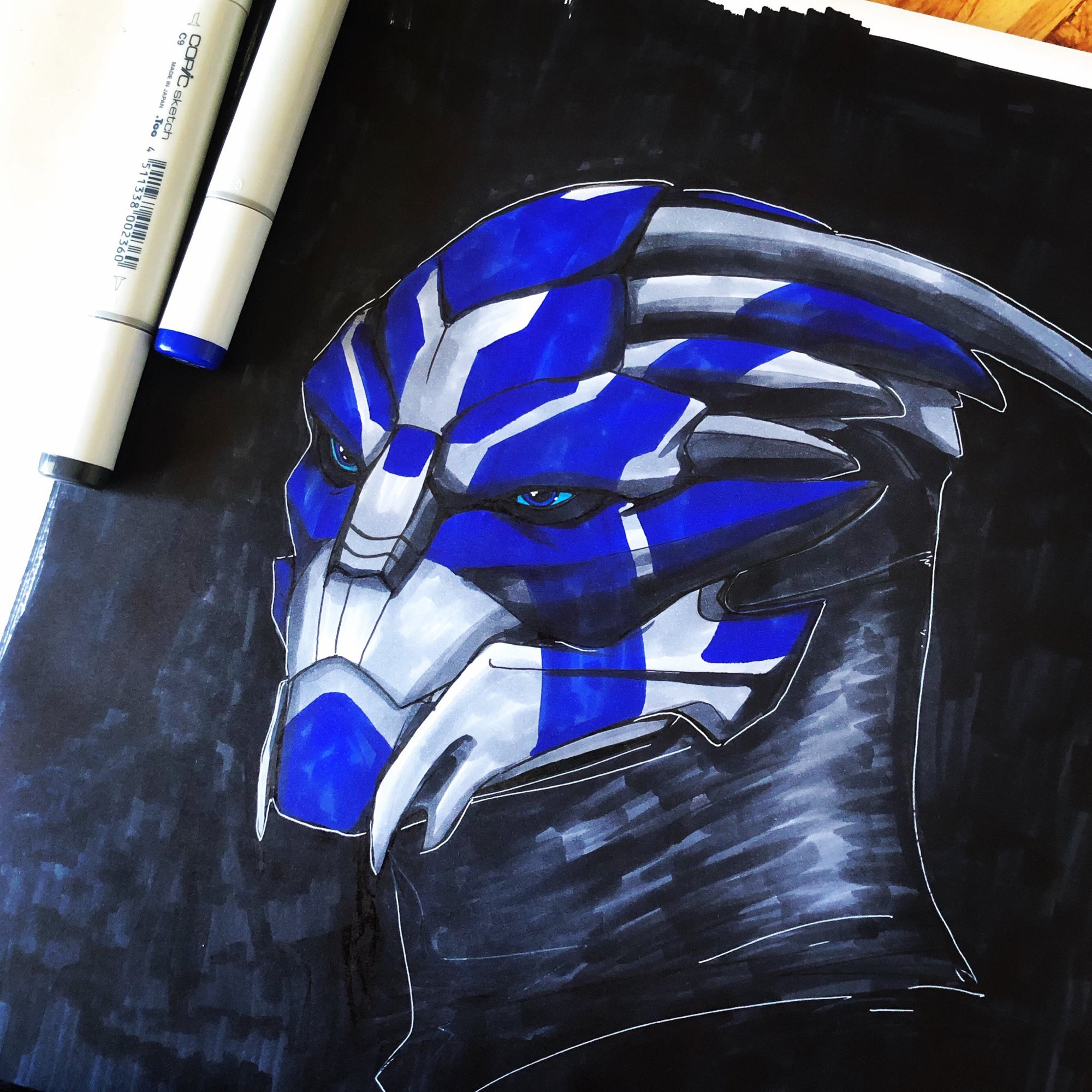 Face sketch of turian character from Mass Effect, his carapace is steely grey with stark cobalt blue face markings. His eyes are light and dark blue.