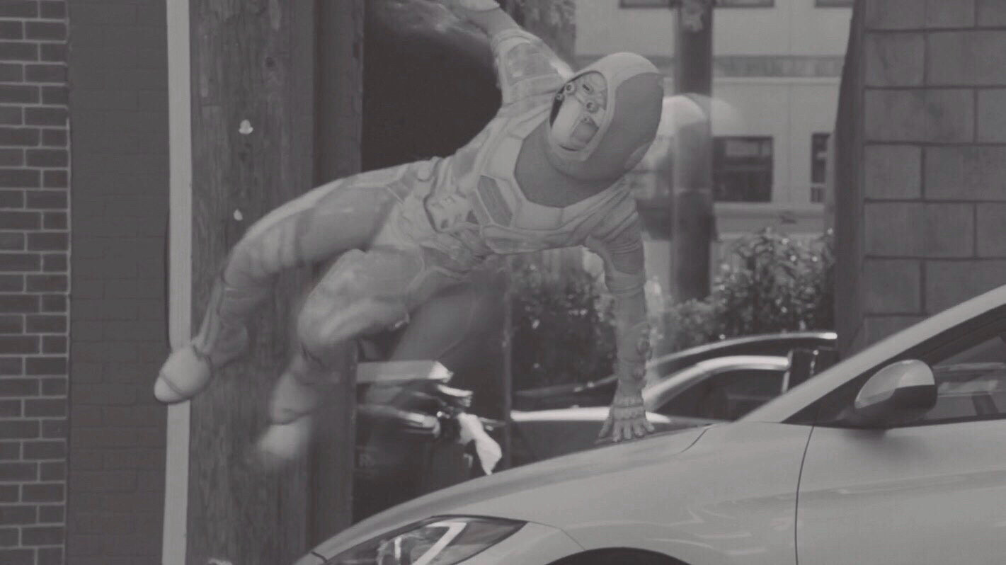 ant-man and the wasp screenshot with muted colours. ava starr, masked, leaping over a car.