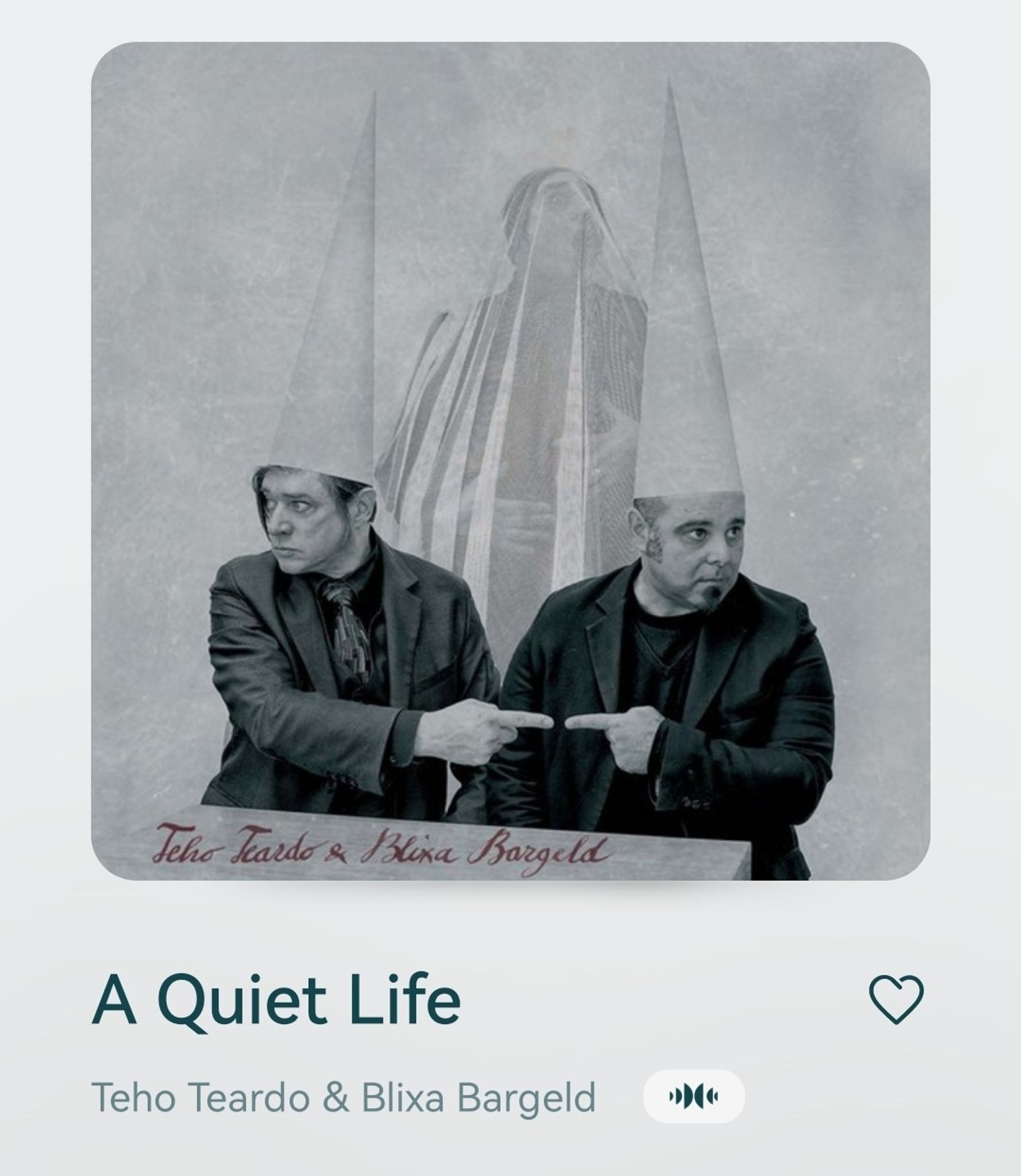 Cover to A Quiet Life by Teha Teardo & Blixa Bargeld, depicted is a black and white photography of both artists wearing cone hats and sitting next to each other, while pointing at the other, their fingers almost touching