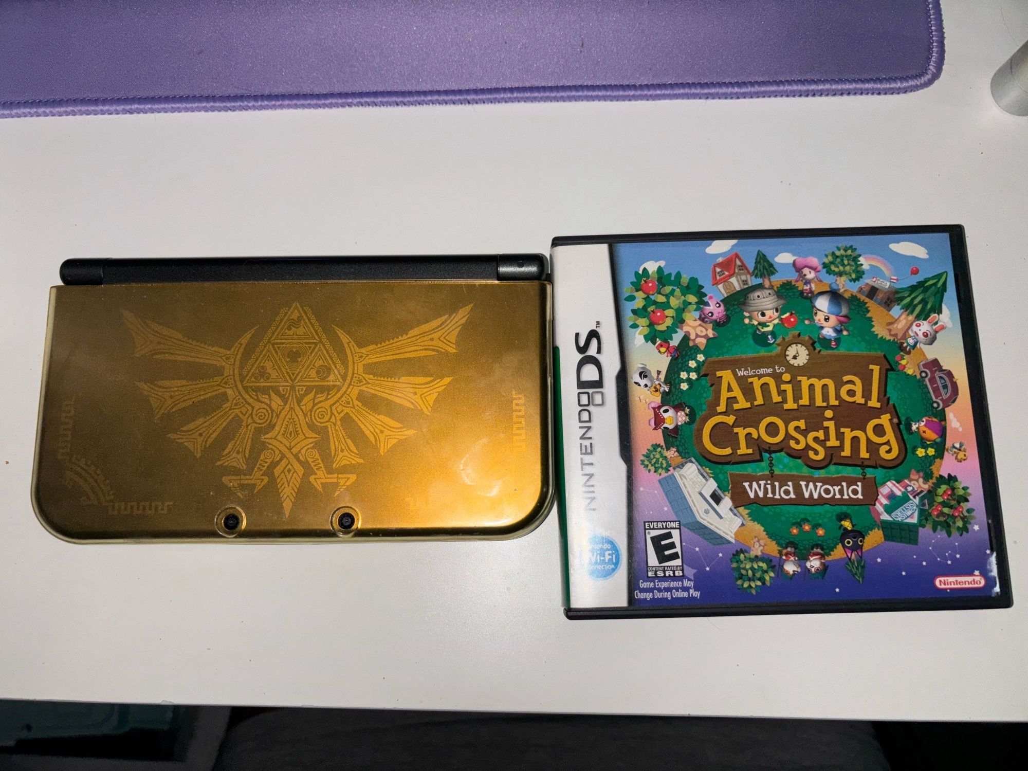 Gold Zelda edition Nintendo 3DS and a copy of Animal Crossing wild world in the case.