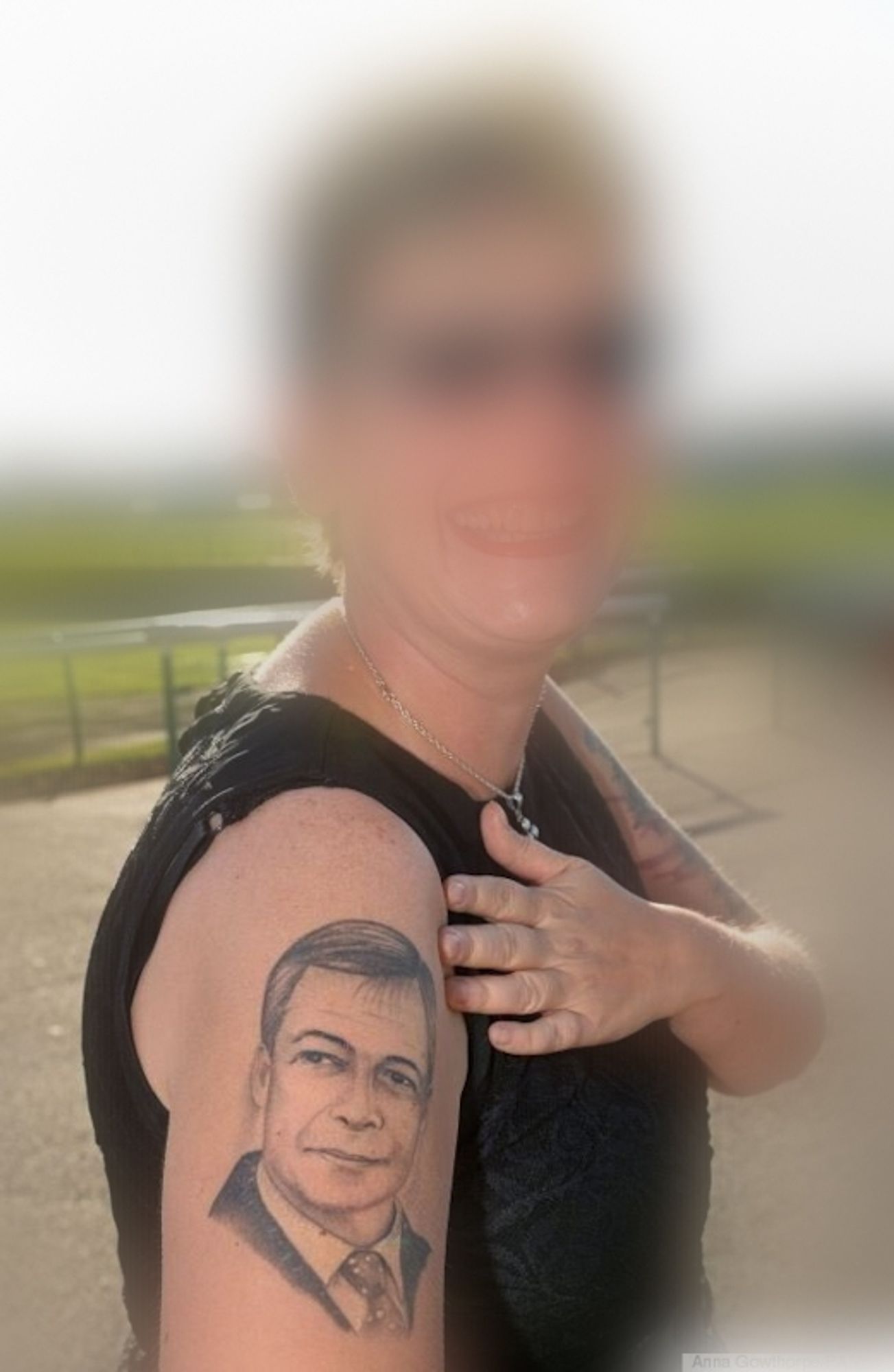 Tattoo of Nigel Farage on woman's shoulder.