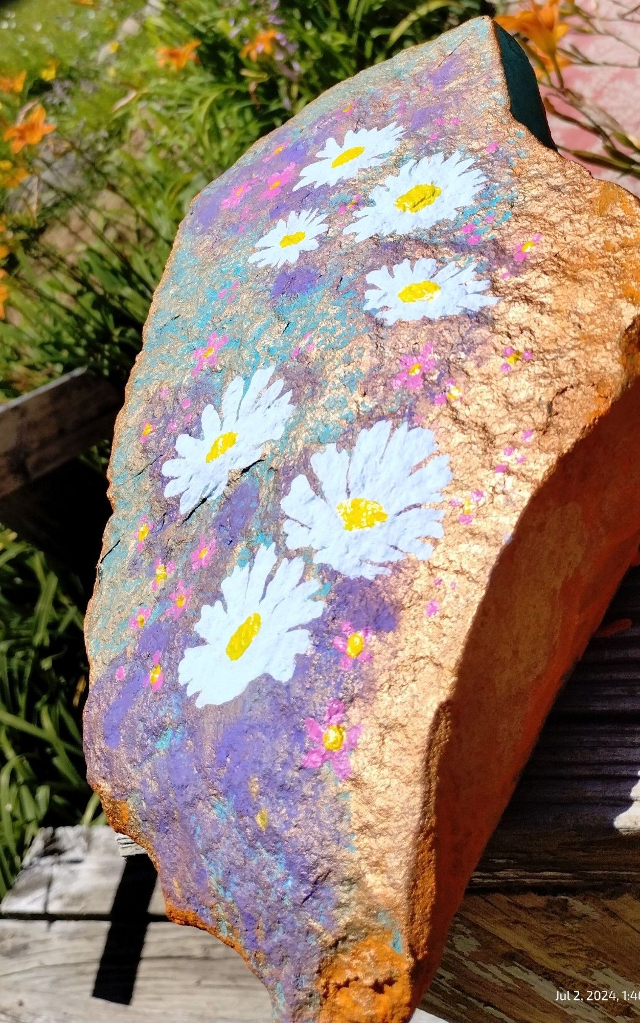 Unexpected Pleasure 
I started painting a rock today.
Daisies on metallic bronze & gold over purple, teal & orange 
ML
24