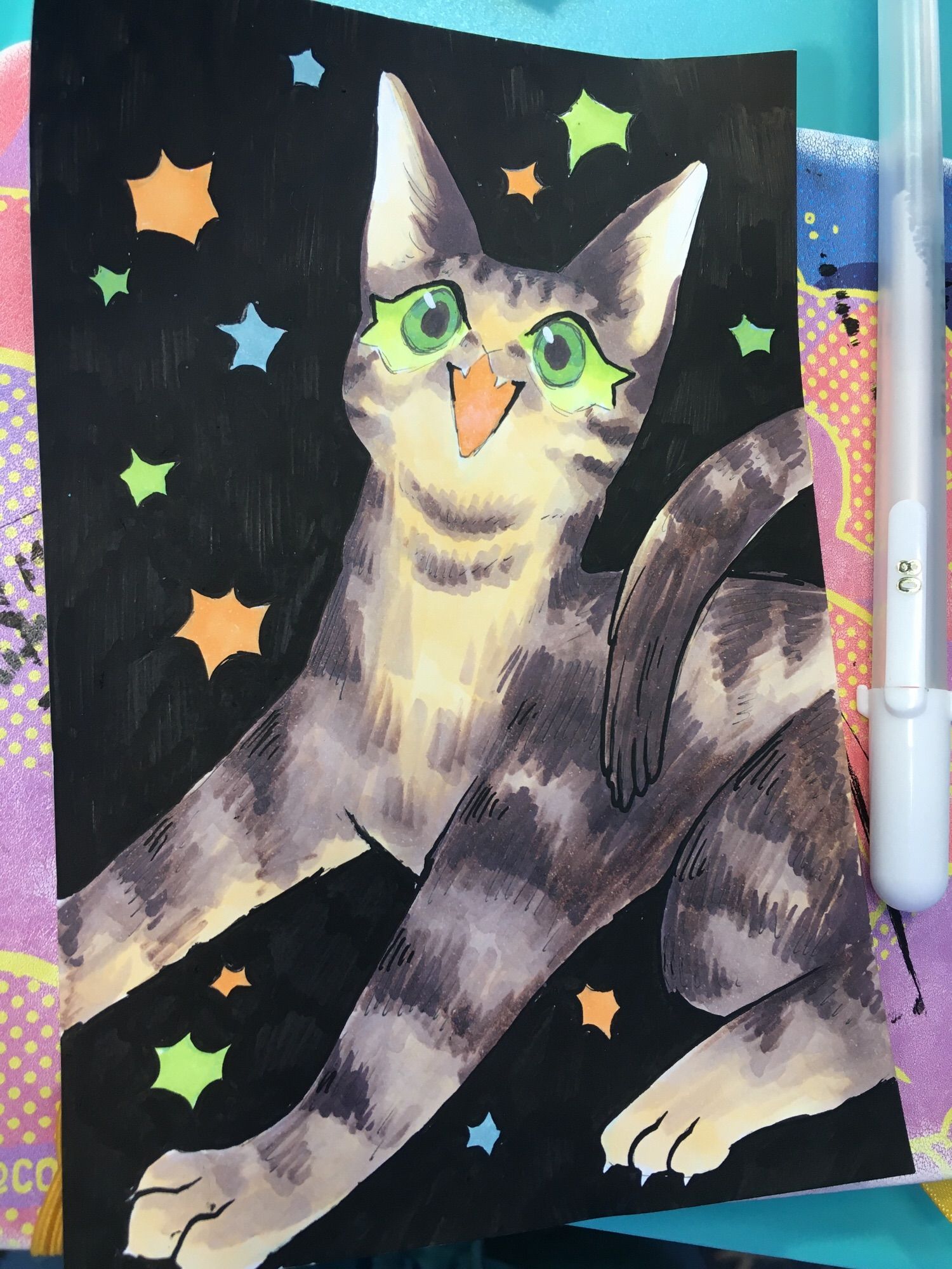 grey/black striped cat with bright green eyes looking up at viewer and meowing enthusiastically. Little sparkles Of green, orange and blue twinkle around them. Done in quick strokes of marker. Background matte black.