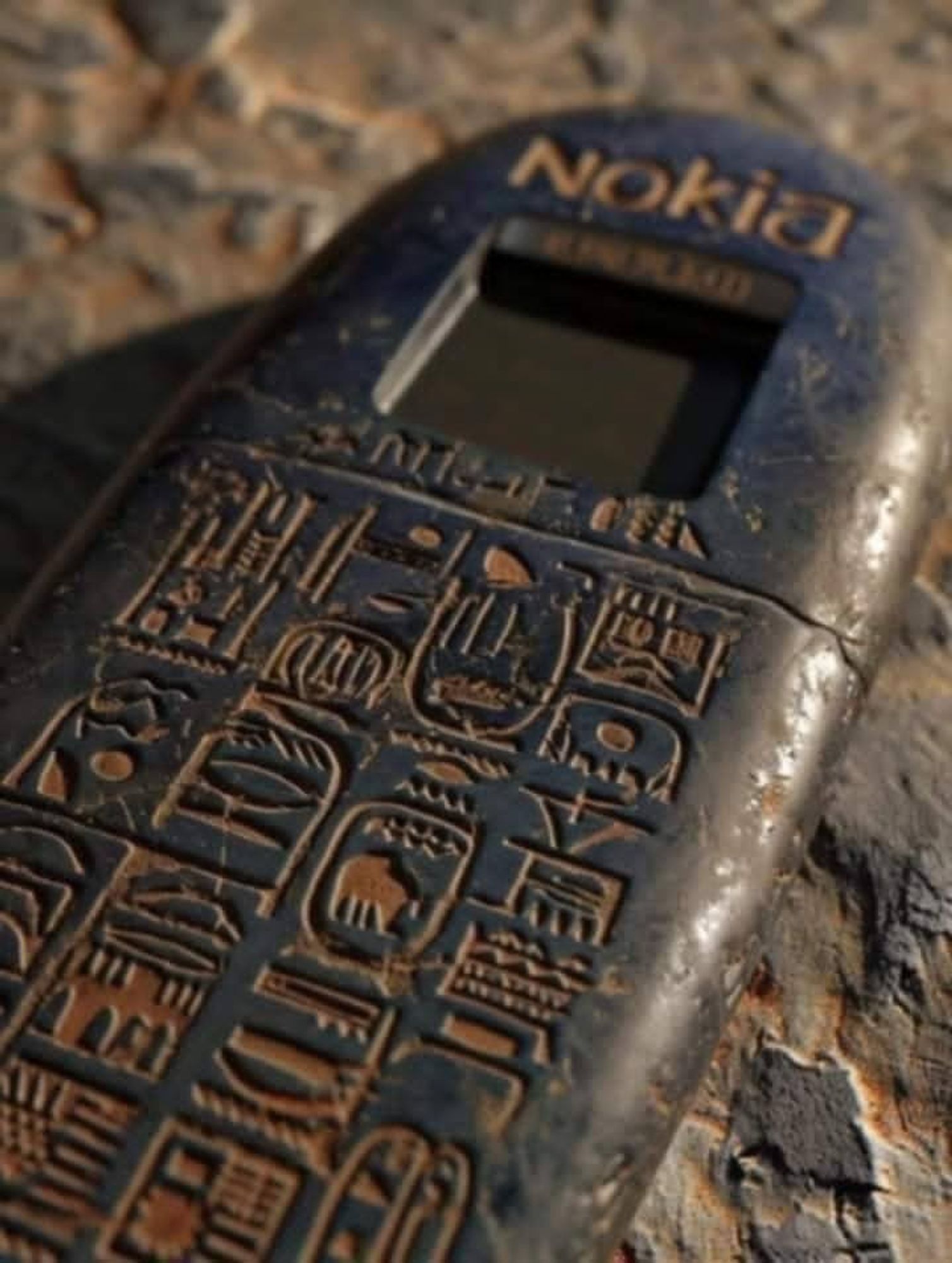 A graven stone tablet in the shape of an old Nokia handset with heiroglyphics for keys and NOKIA blazoned across the top.