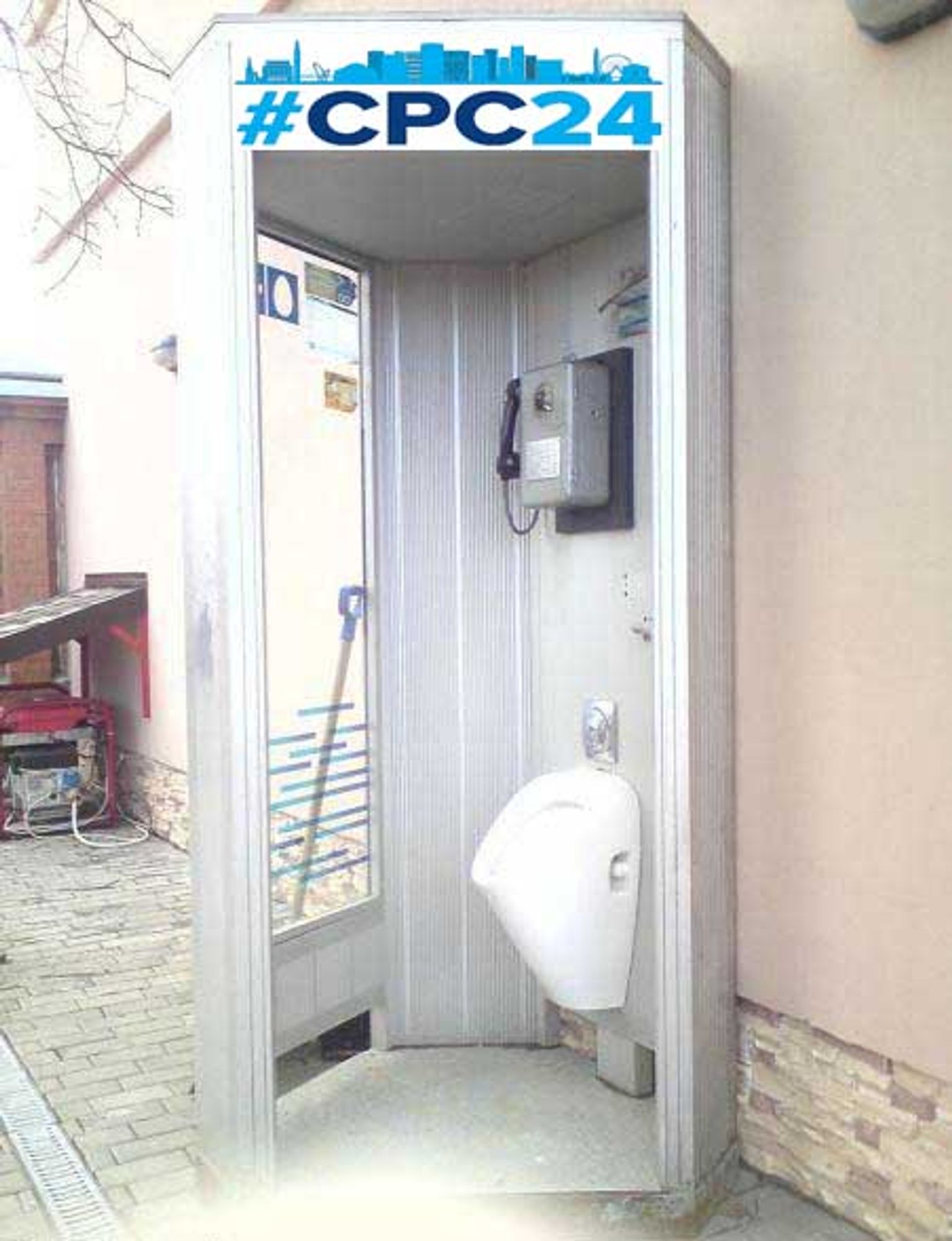 A telephone kiosk with a urinal installed below the telephone and the logo from the 2024 Conservative Party Conference pasted above its entrance.