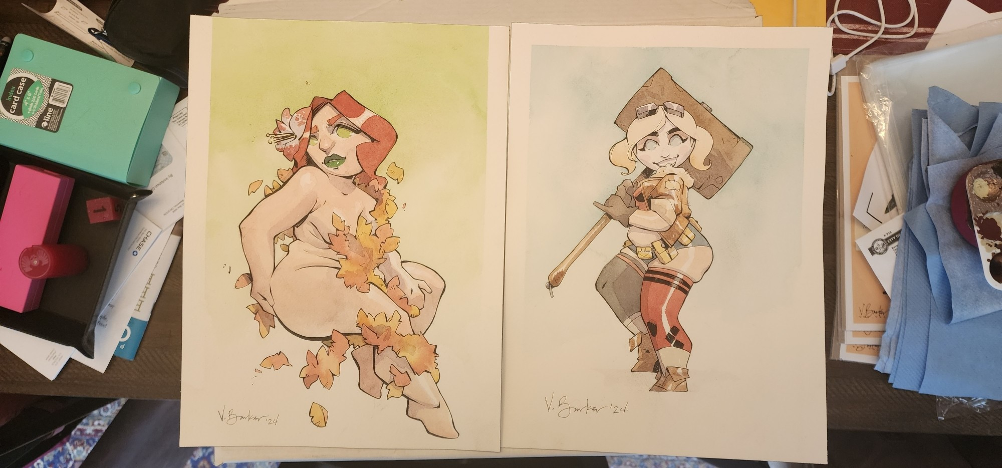 Two watercolor paintings of cartoon women. On the left is Poison Ivy, from DC Comics, covered in fall foliage and nothing else. On the right is Harley Quinn, also from DC Comics in her 1940's-inspired Bombshell garb.