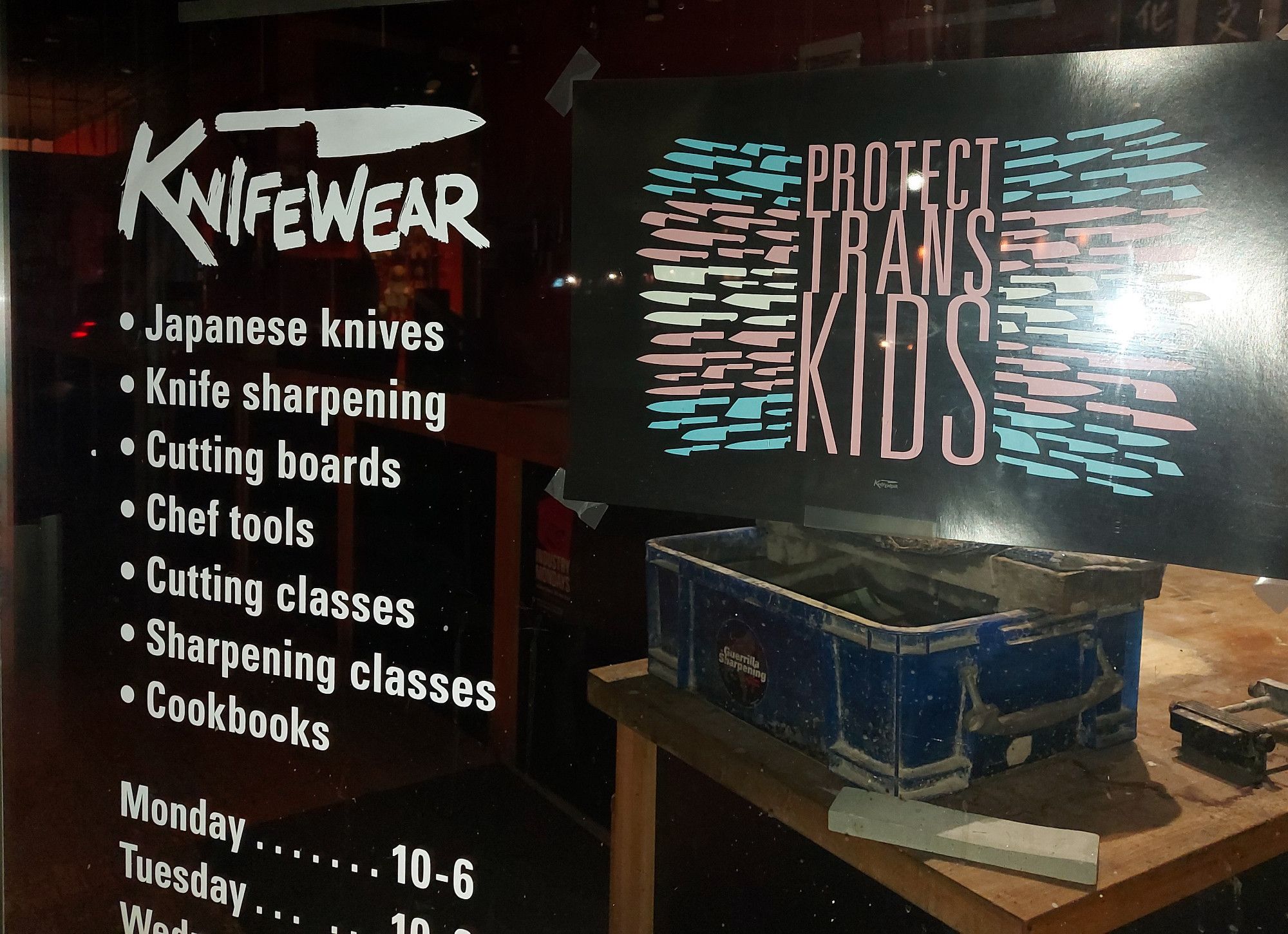 Knifewear sign looking like a flag, made of knives, saying PROTECT TRANS KIDS