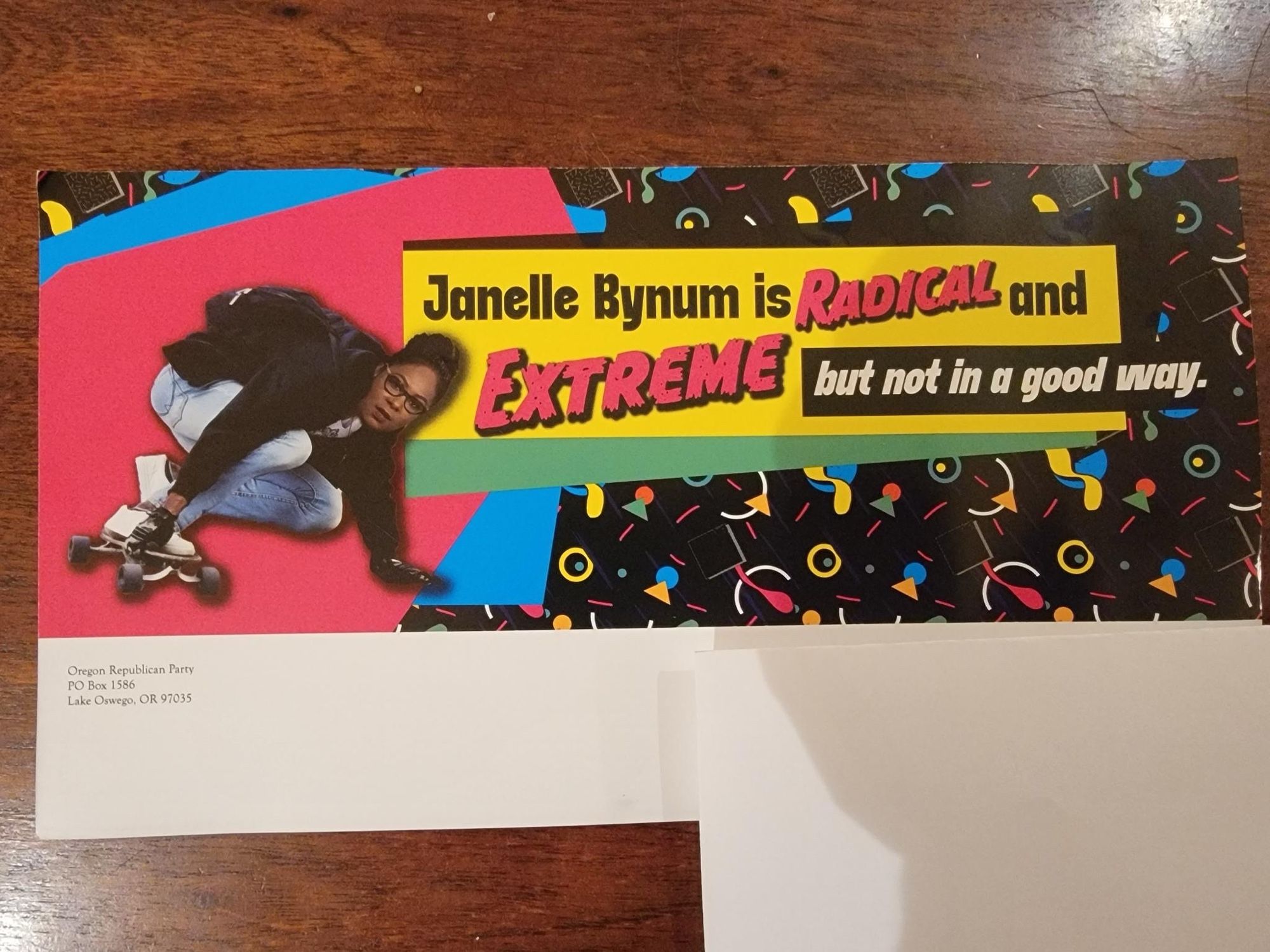 A campaign postcard from the Oregon Republican Party saying "Janelle Bynum is RADICAL and EXTREME but not in a good way." The postcard is done in an 80s style with Bynum photoshopped on a skateboard looking... pretty cool.