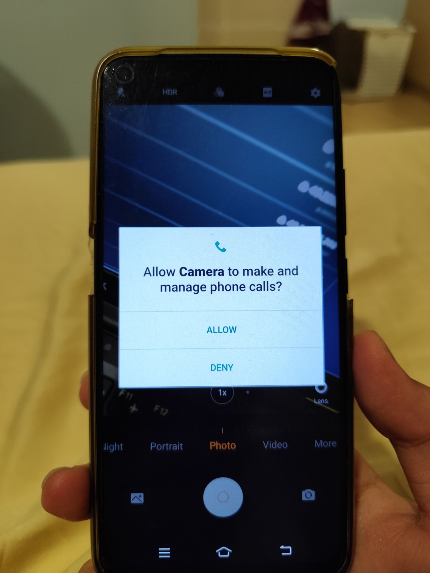 A pop-up of a camera app saying "Allow Camera to make and manage phone calls".