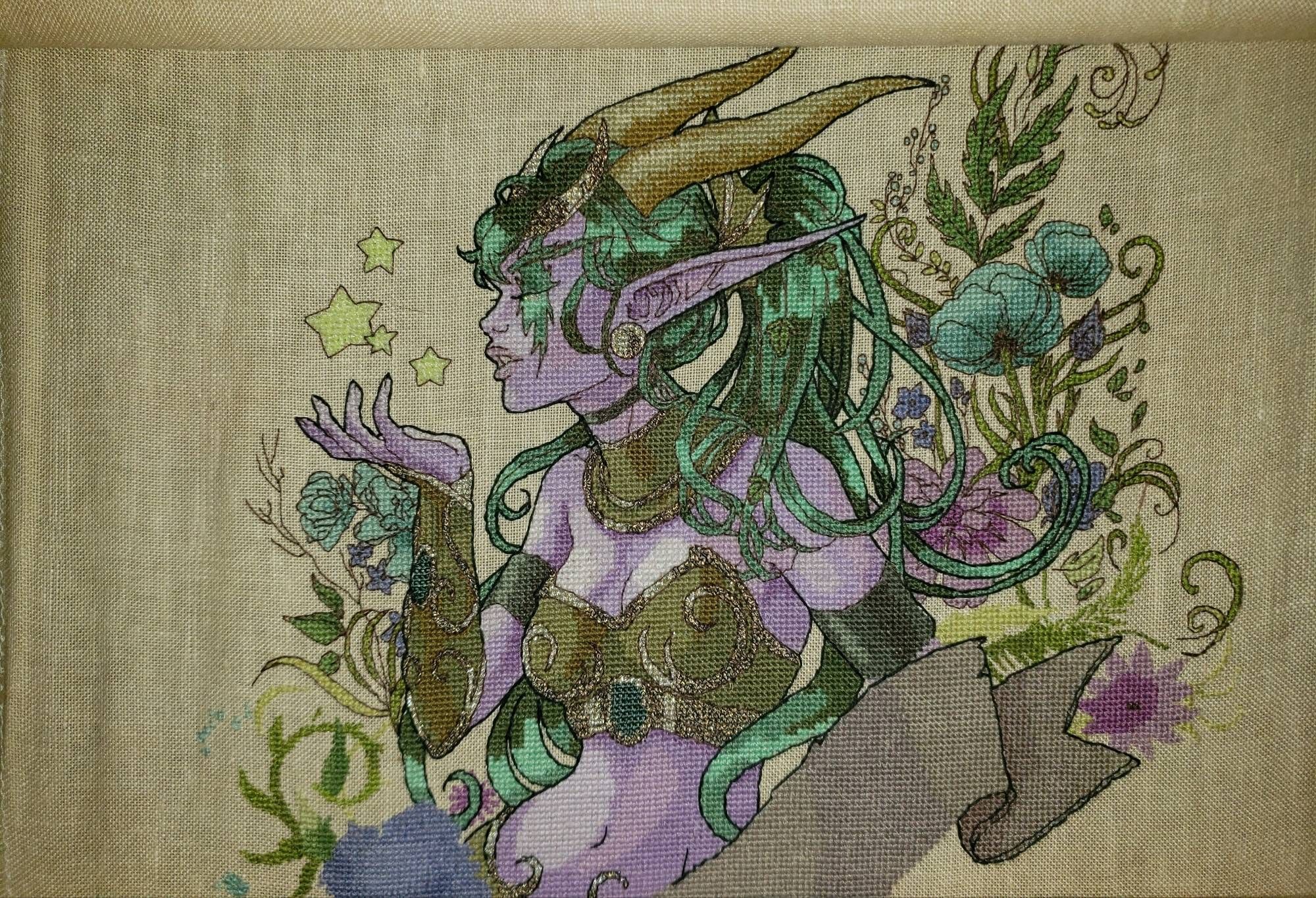 A detailed, in progress, cross stitch of Ysera in Night Elf form from World of Warcraft.