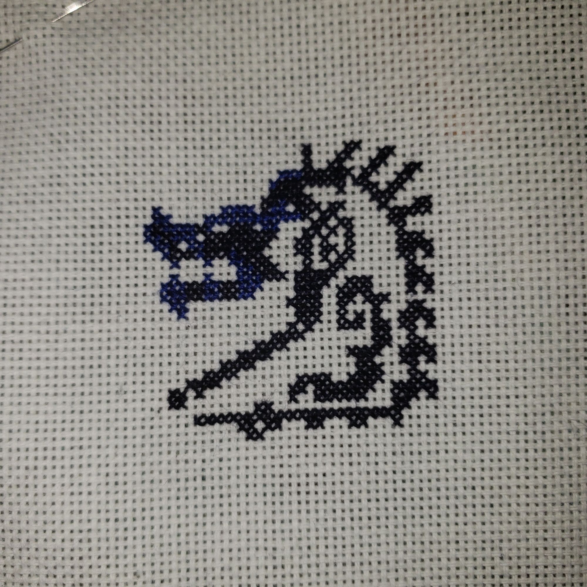 The beginnings of a Brachydios icon cross stitch.