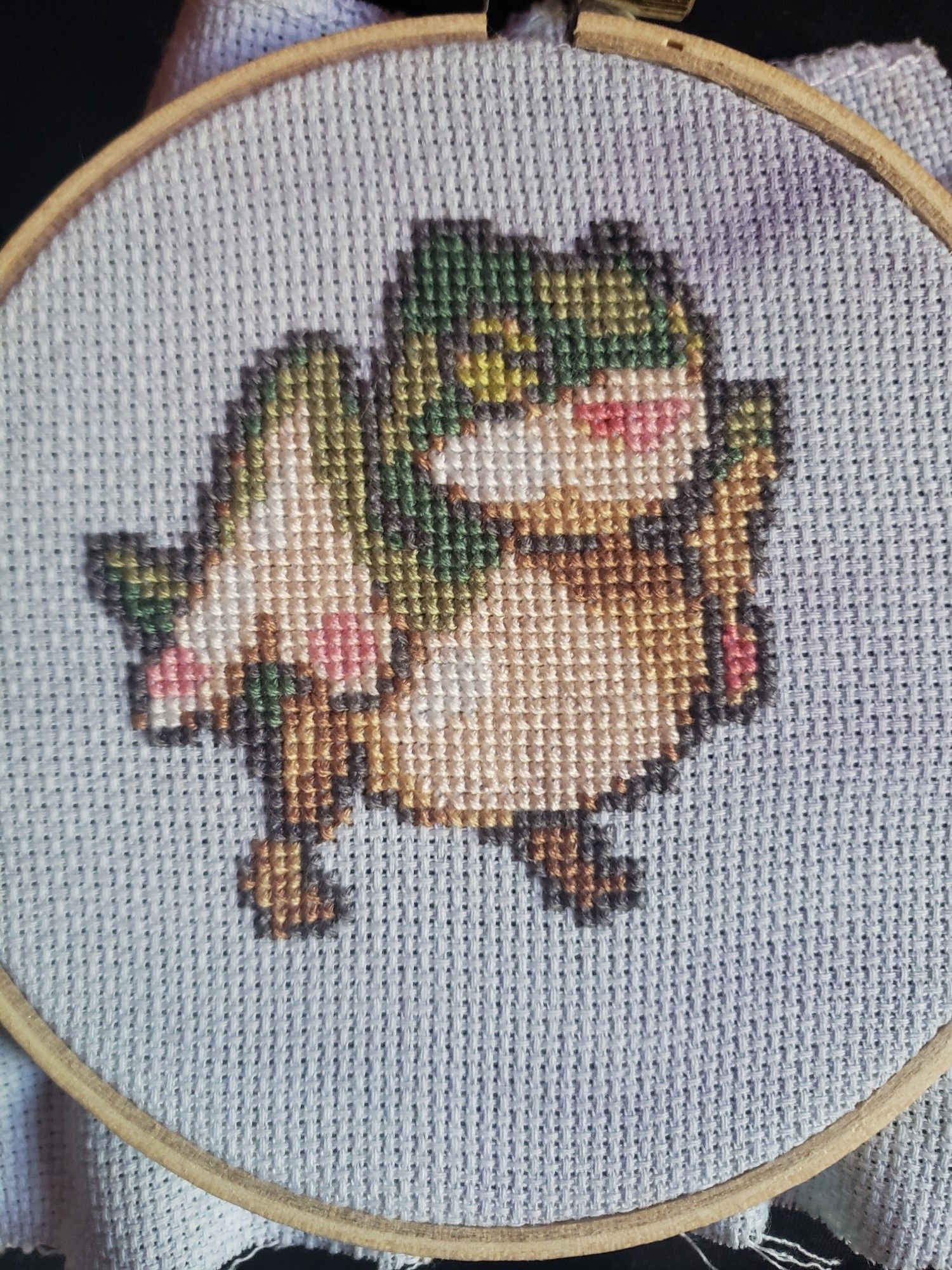 Cross stitched baby pukei pukei. Original pixel art by gandalfsoda on Twitter.