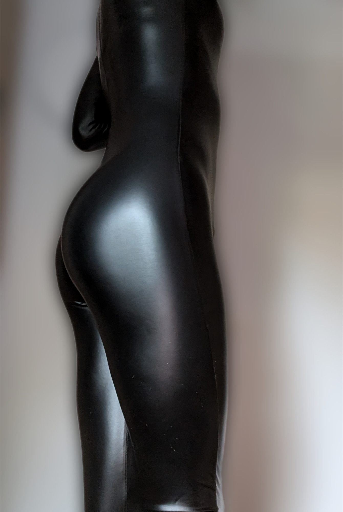 A picture of my butt in a shiny black catsuit