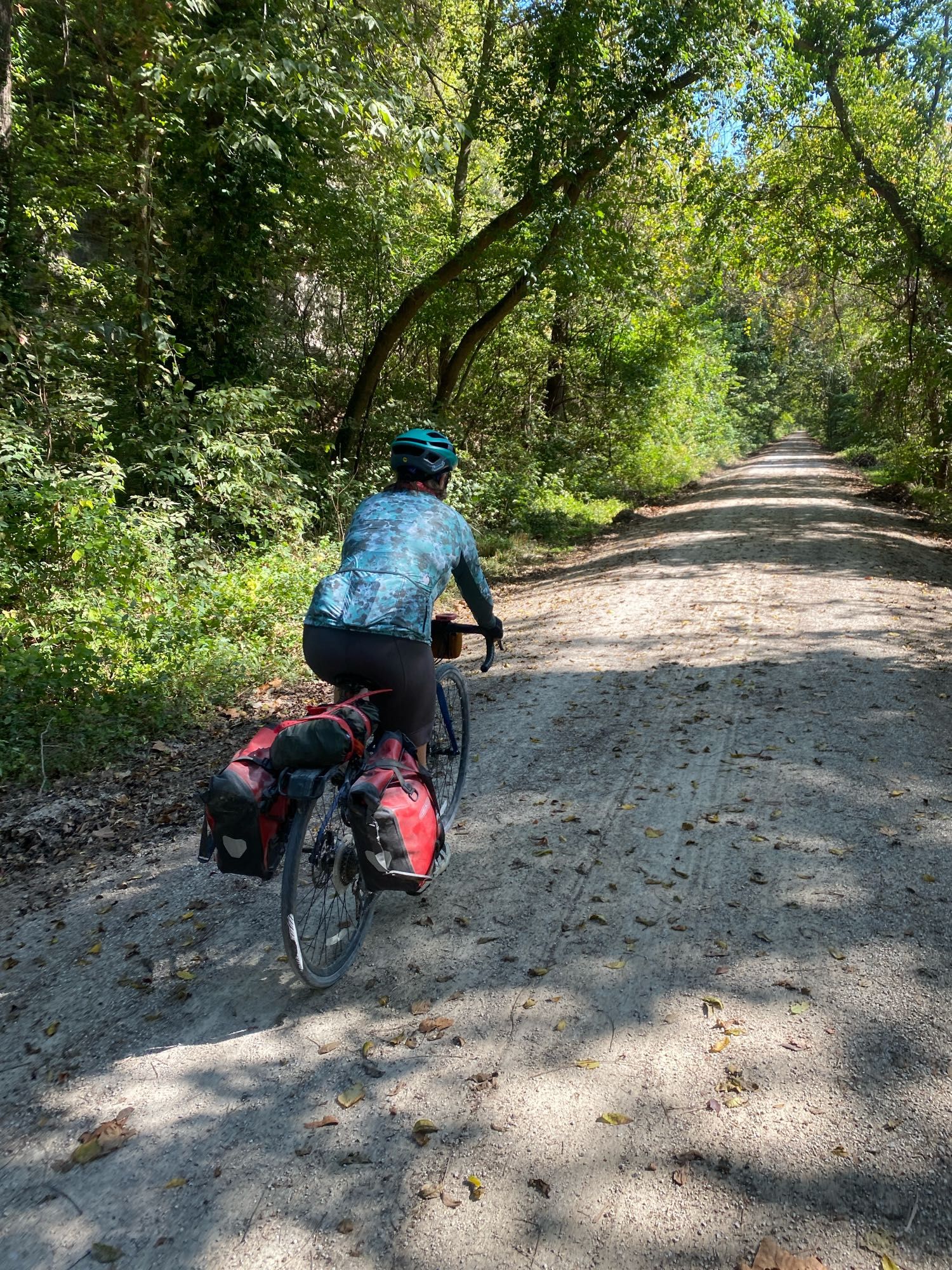 Carmen pedaling her loaded down gravel bike along the trail.