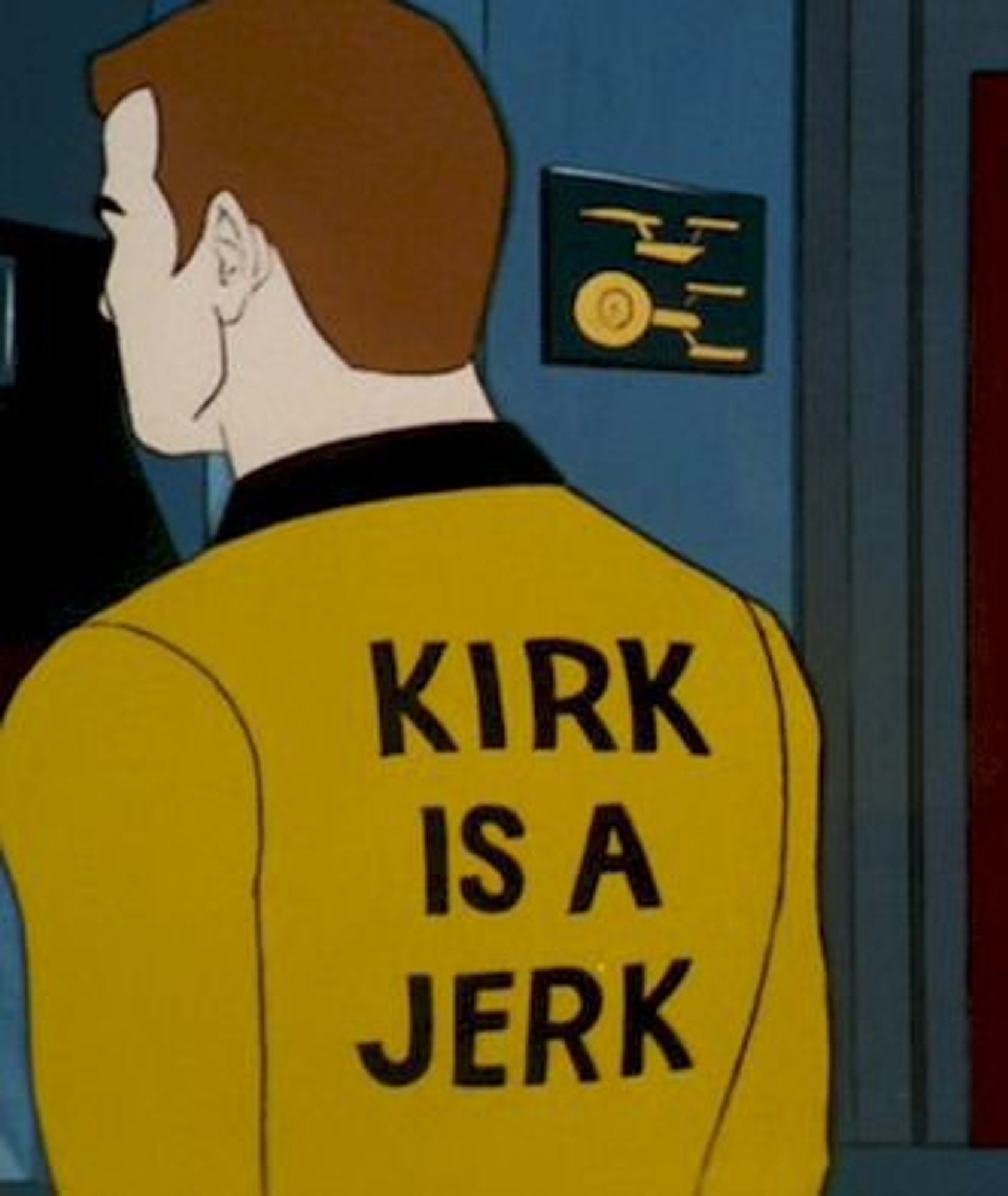 Still from STAR TREK THE ANIMATED SERIES: Kirk stands with his back to the viewer with "KIRK IS A JERK" on his back.