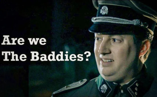 Screenshot of film scene with the quote "Are we the baddies?"