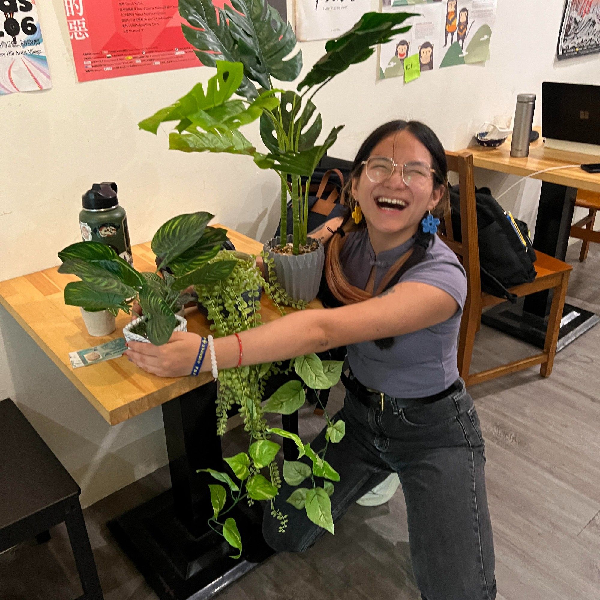 Person happy to see fake plants attempts to hug them all at once