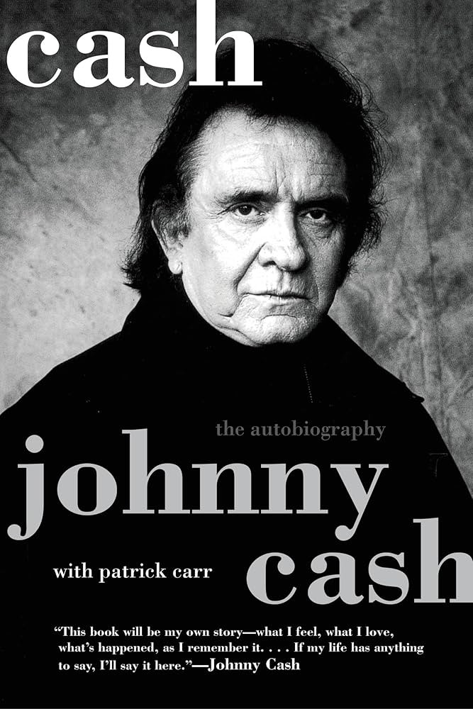 Black and white book cover of Johnny Cash when he's older. He's looking into the camera with a neutral expression. The text says "cash the autobiography" and "johnny cash with patrick carr" and "This book will be my own story - what I feel, what I love, what's happened, as I remember it. If my life has anything to say, I'll say it here' - Johnny Cash".