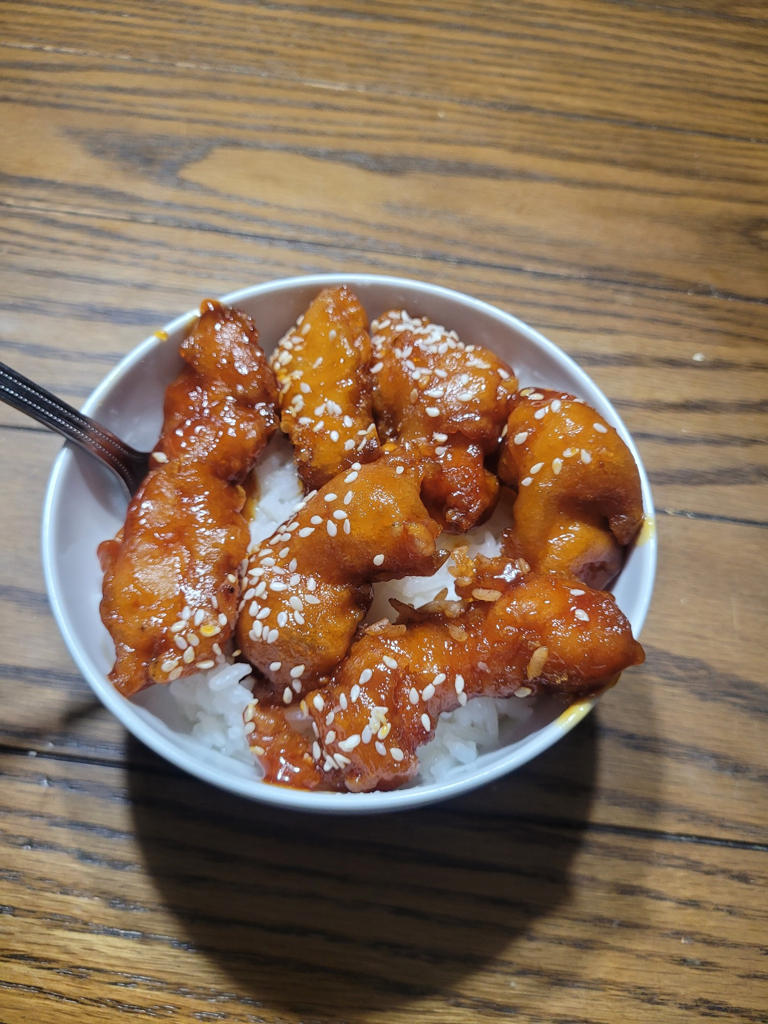 sesame seed chicken on a bed of rice