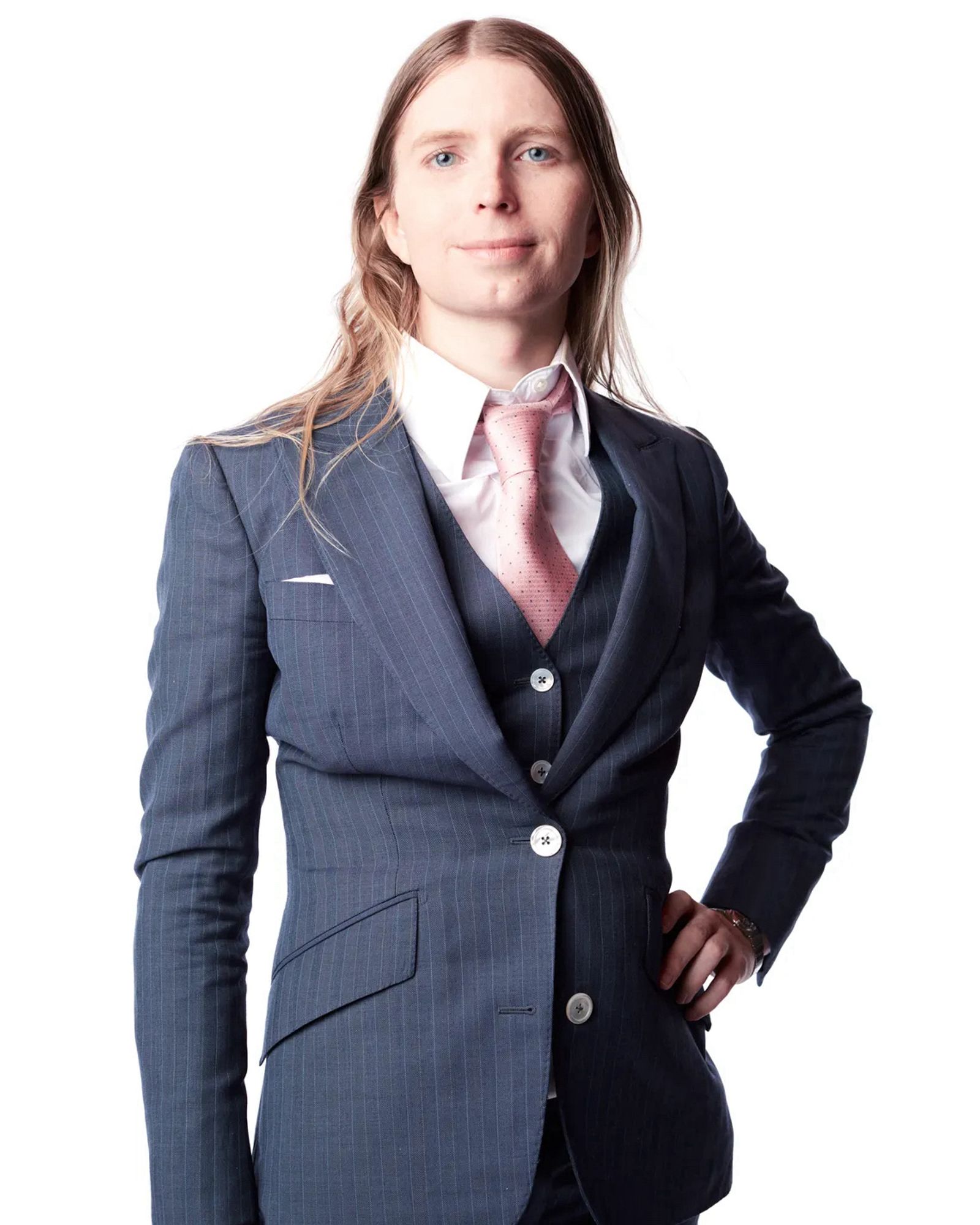 Photo of Chelsea Manning for Curbed/New York Magazine by Frankie Aldunio at the 33rd Issue Butt Magazine celebration in lower Manhattan three weeks ago. The background is white and Chelsea is wearing a navy pinstripe suit with a pink tie.