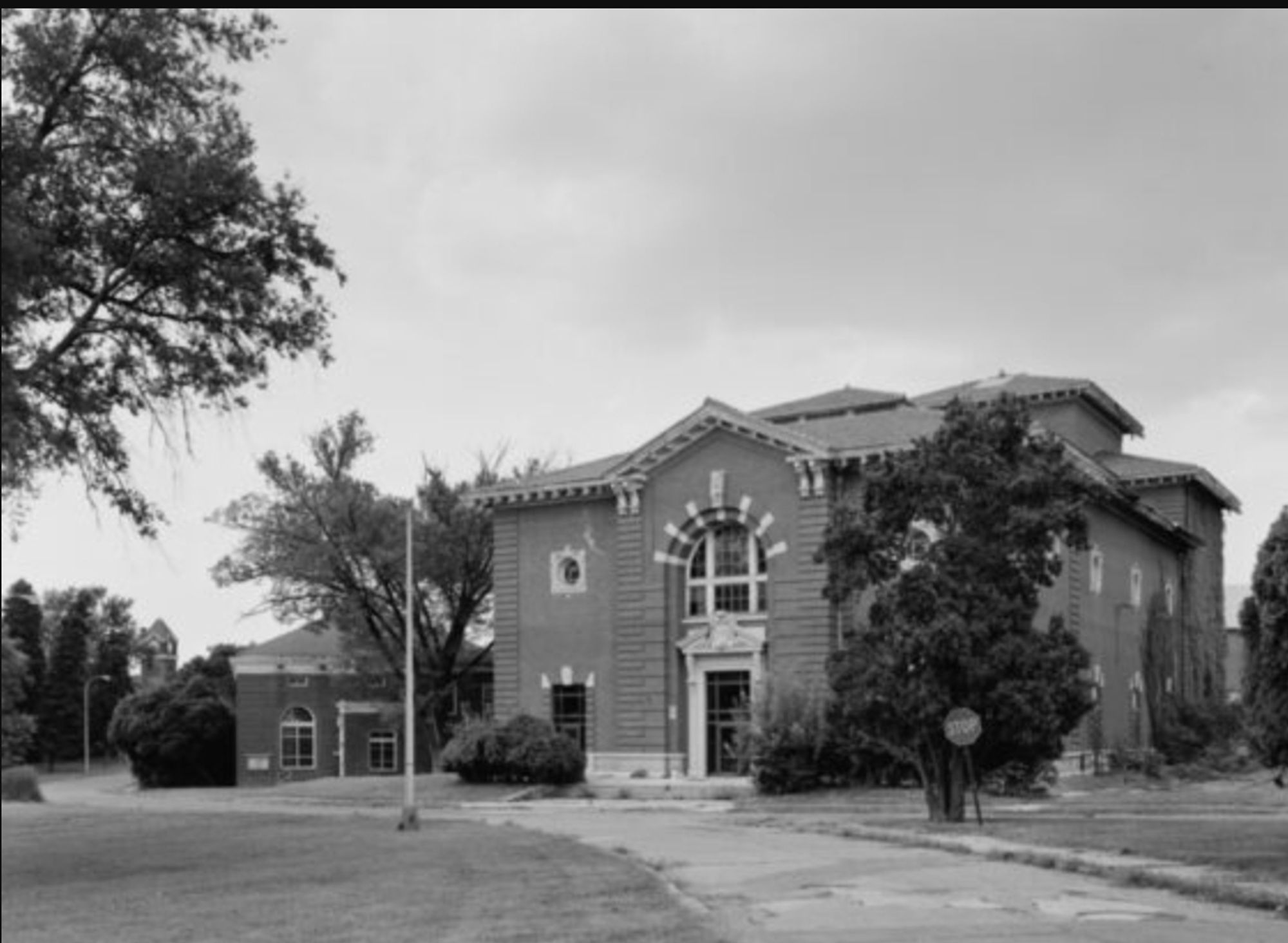 A black and white image of a two-story brick structure surrounded by deciduous trees. A road leads up to the building. 

Caption: St. Elizabeth’s Hospital in Washington D.C., one of only two mental asylums ever operated by the U.S. federal government (Courtesy of the Library of Congress)