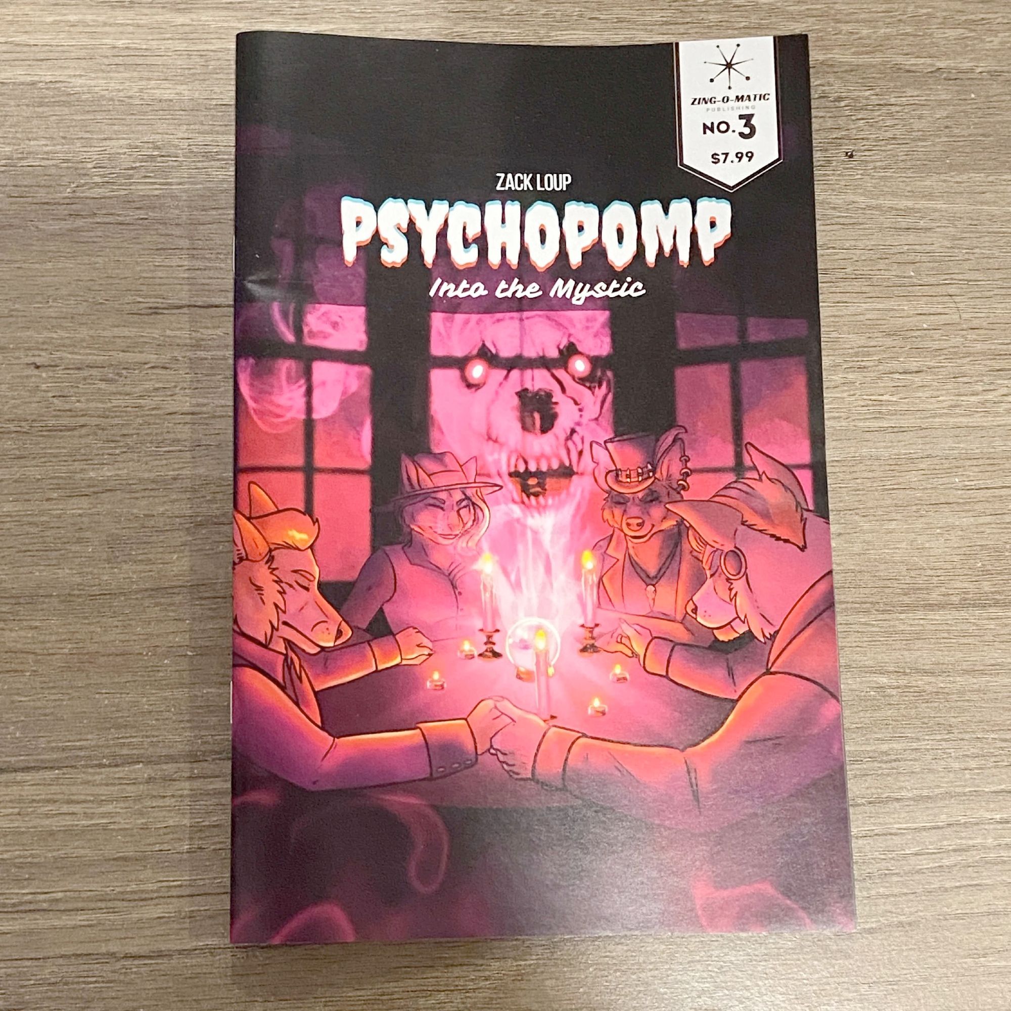 Cover of Issue 3 of Psychopomp, Into the Mystic,  a comicby Zack Loup. It features art of a group of anthro animals doing a seance. In the center is a ghostly skull with glowing red eyes.