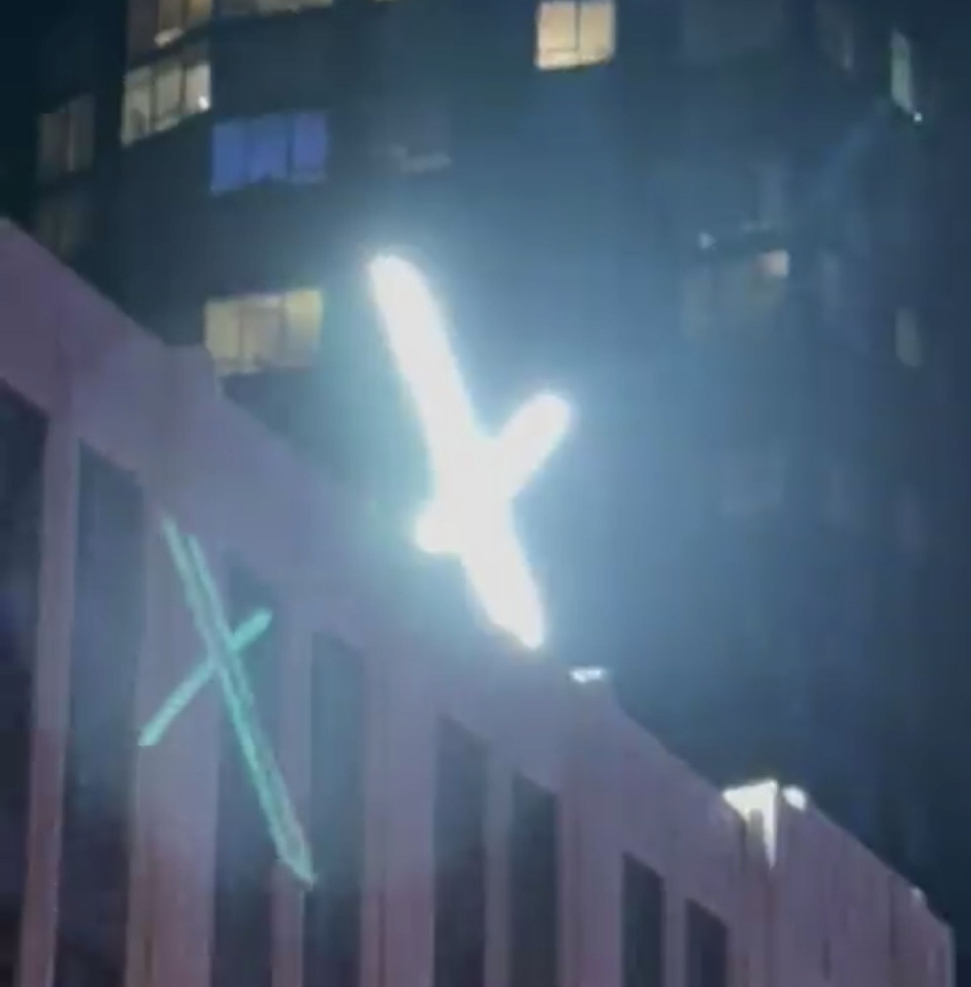 the annoying dorky x logo on the twitter building, but lit up at night. and it flashes!