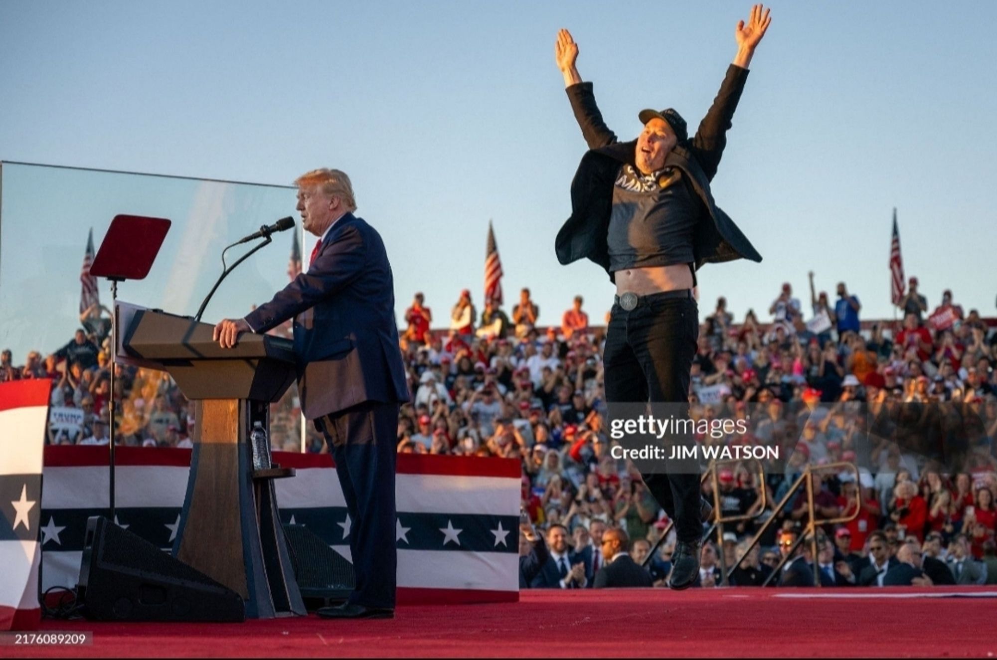 That awful photo of Trump speaking behind his bulletproof glass and Elon jumping in the air