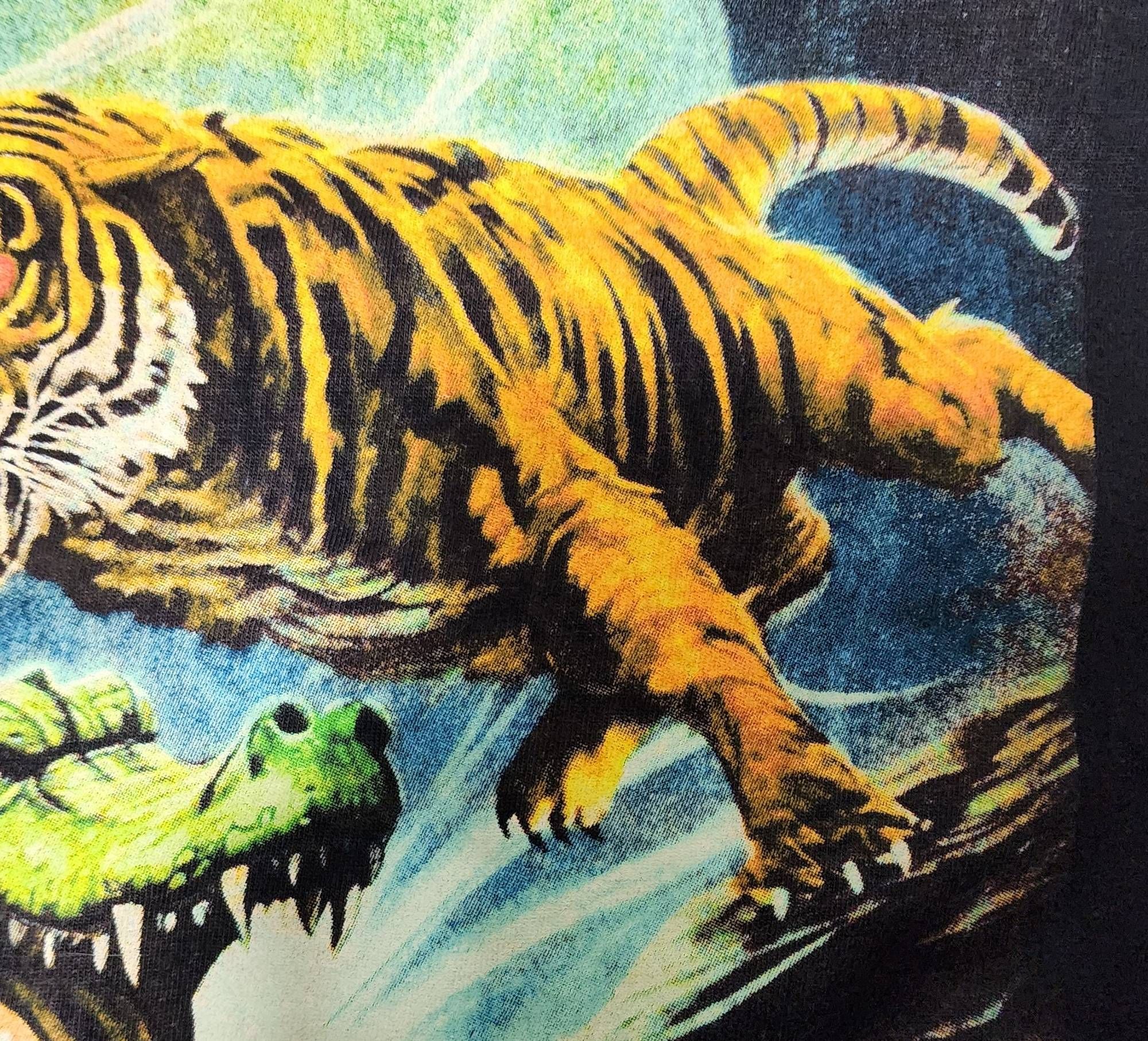 A detail of the shirt showing the tiger's body. It's lumpy and doesn't make much sense the stripes are strangely smudged.